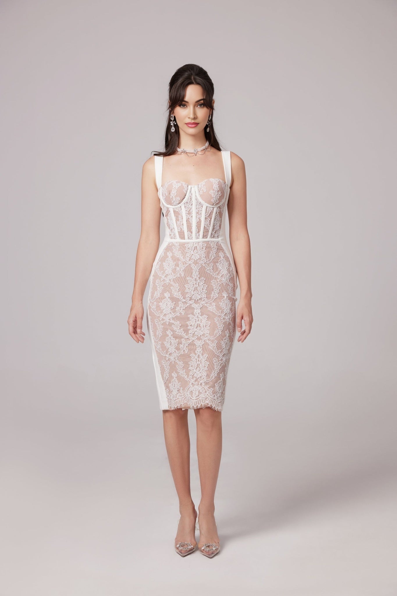 A fitted midi dress with a bustier style top in a bandage fabric design