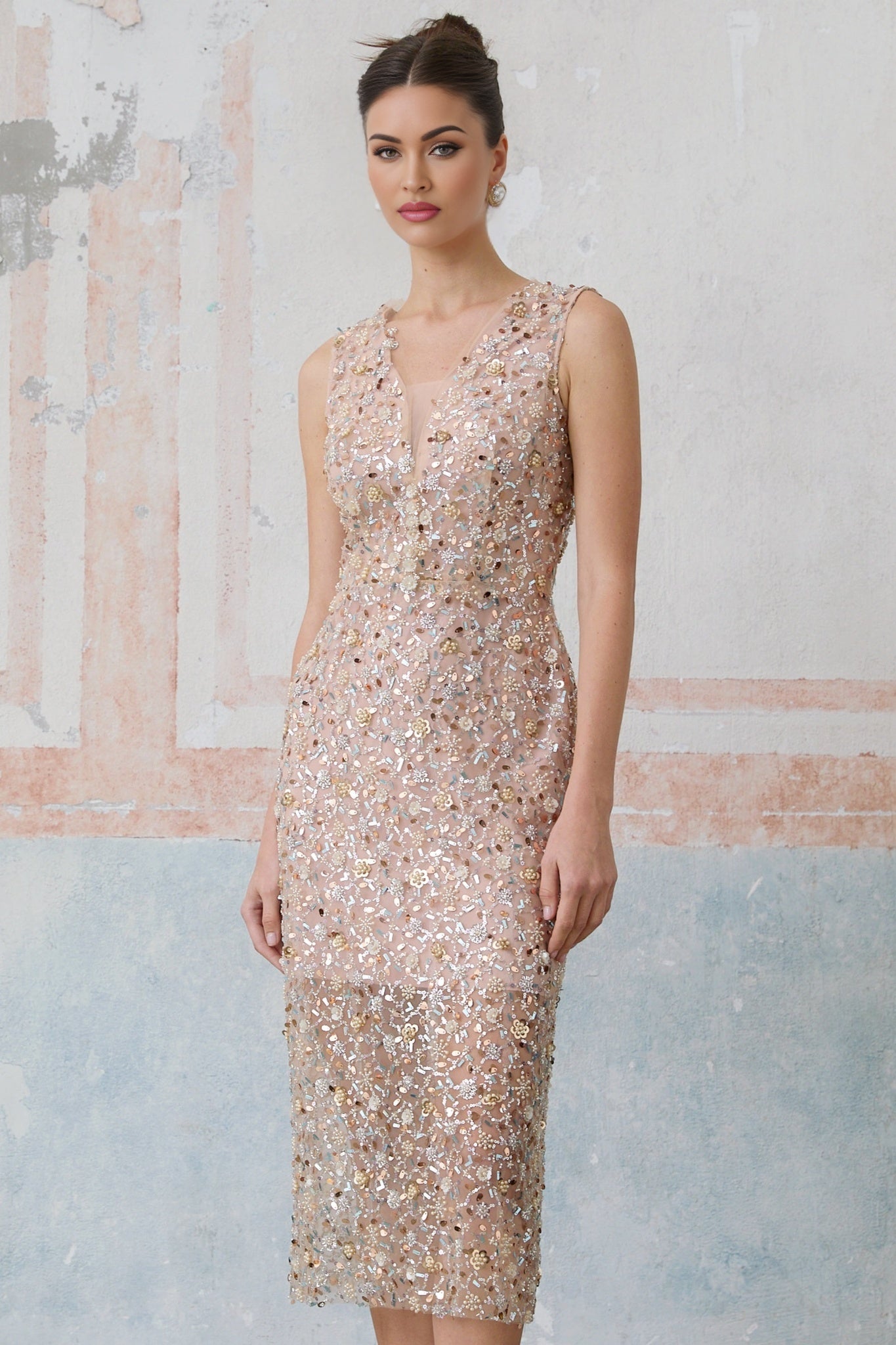 A fitted midi dress with an embellished floral pattern featuring marguerite flower motifs