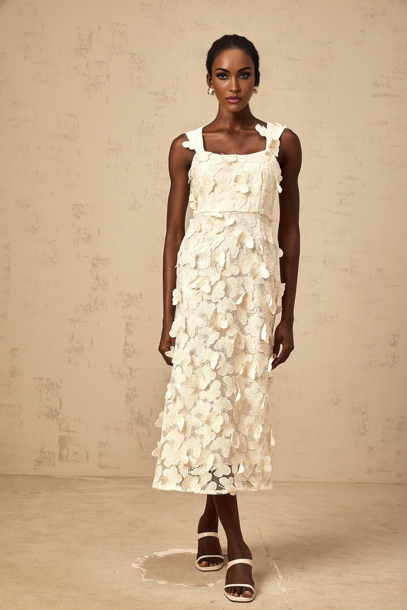 A flared midi dress with butterfly appliques adorning the fabric The dress features a fitted bodice and flowing skirt in a soft color palette evoking the delicate beauty of narcissus flowers