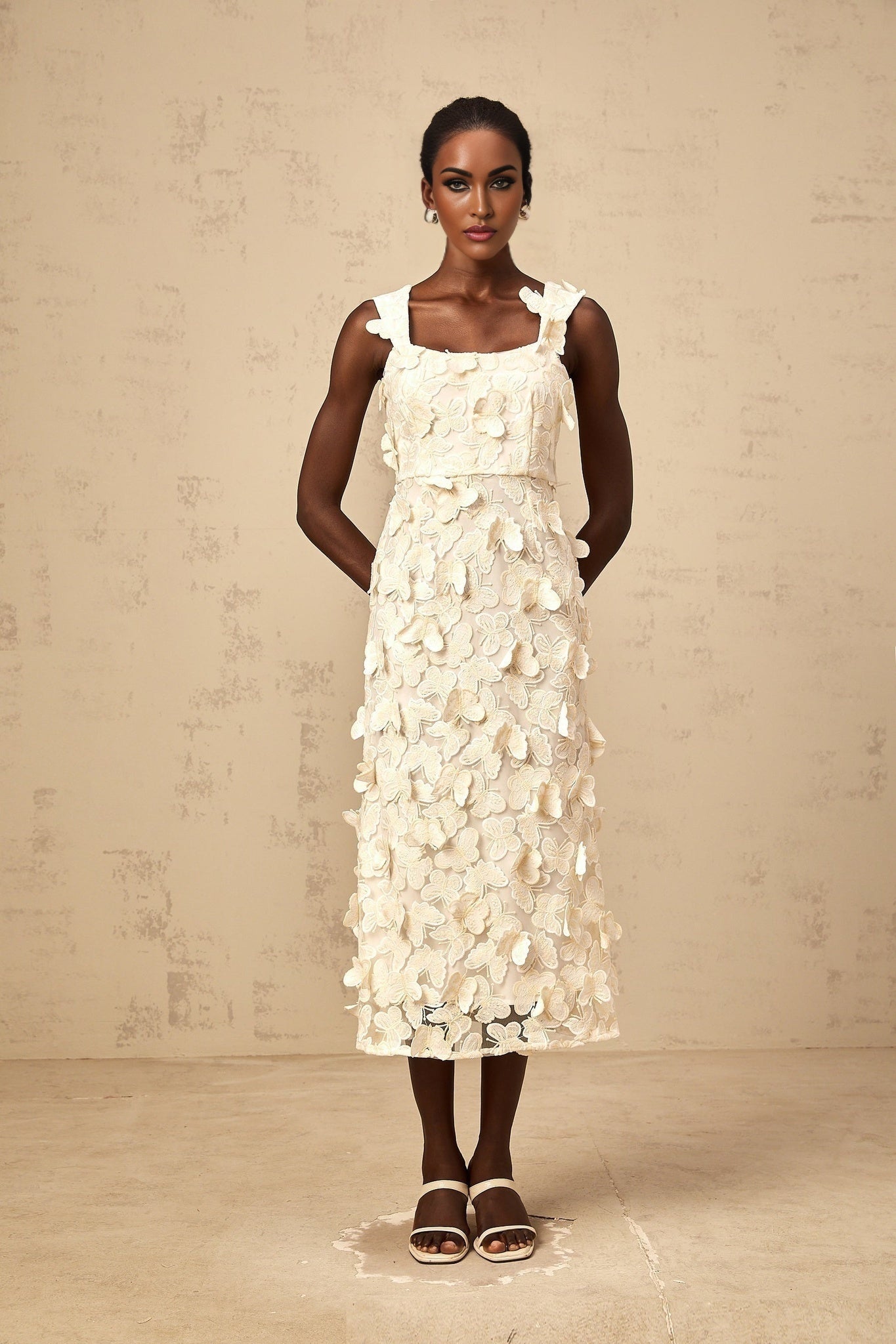A flared midi dress with butterfly appliques featuring a design inspired by the Narcisse style