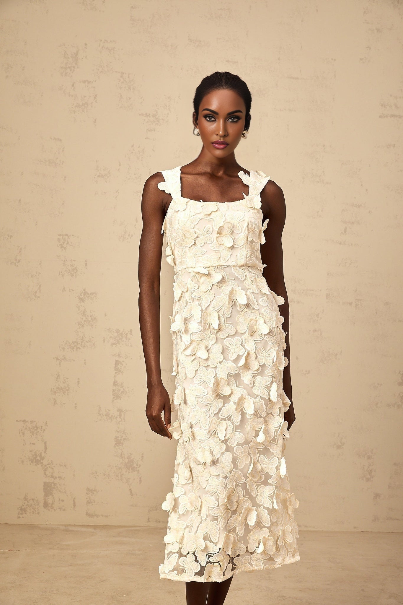 A flared midi dress with butterfly appliques featuring a design inspired by the Narcisse style