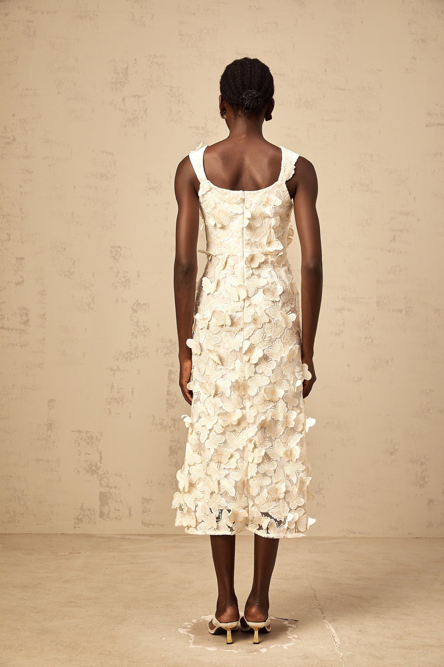A flared midi dress with butterfly appliques featuring a Narcisse design