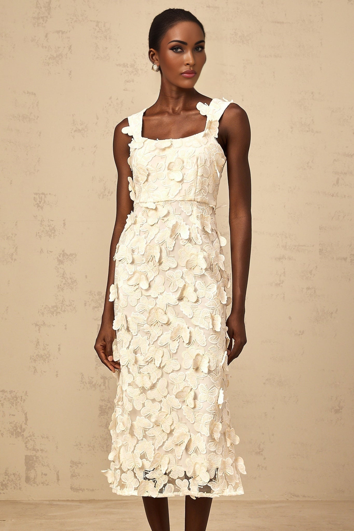 A flared midi dress with butterfly appliques in a Narcisse style