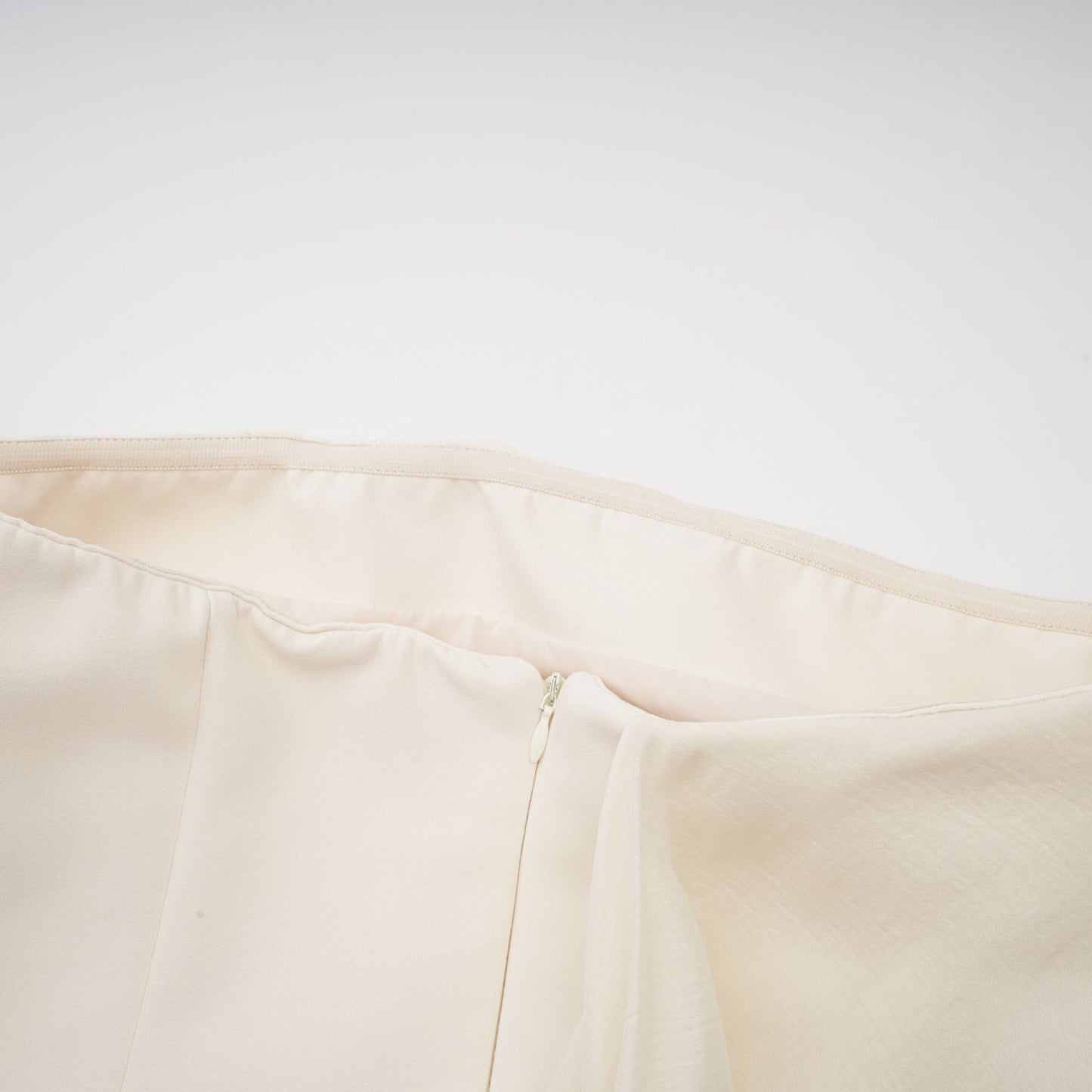 A flared mini dress with a ribbon design named Danae featuring a short skirt and decorative ribbon elements throughout the fabric
