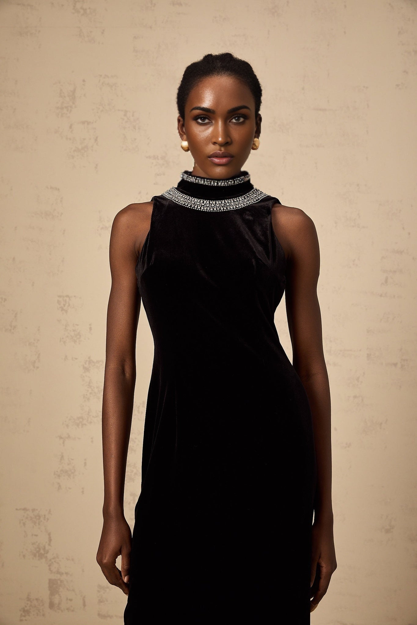 A floorlength black velvet gown with crystal embellishments and a fitted silhouette named Colette
