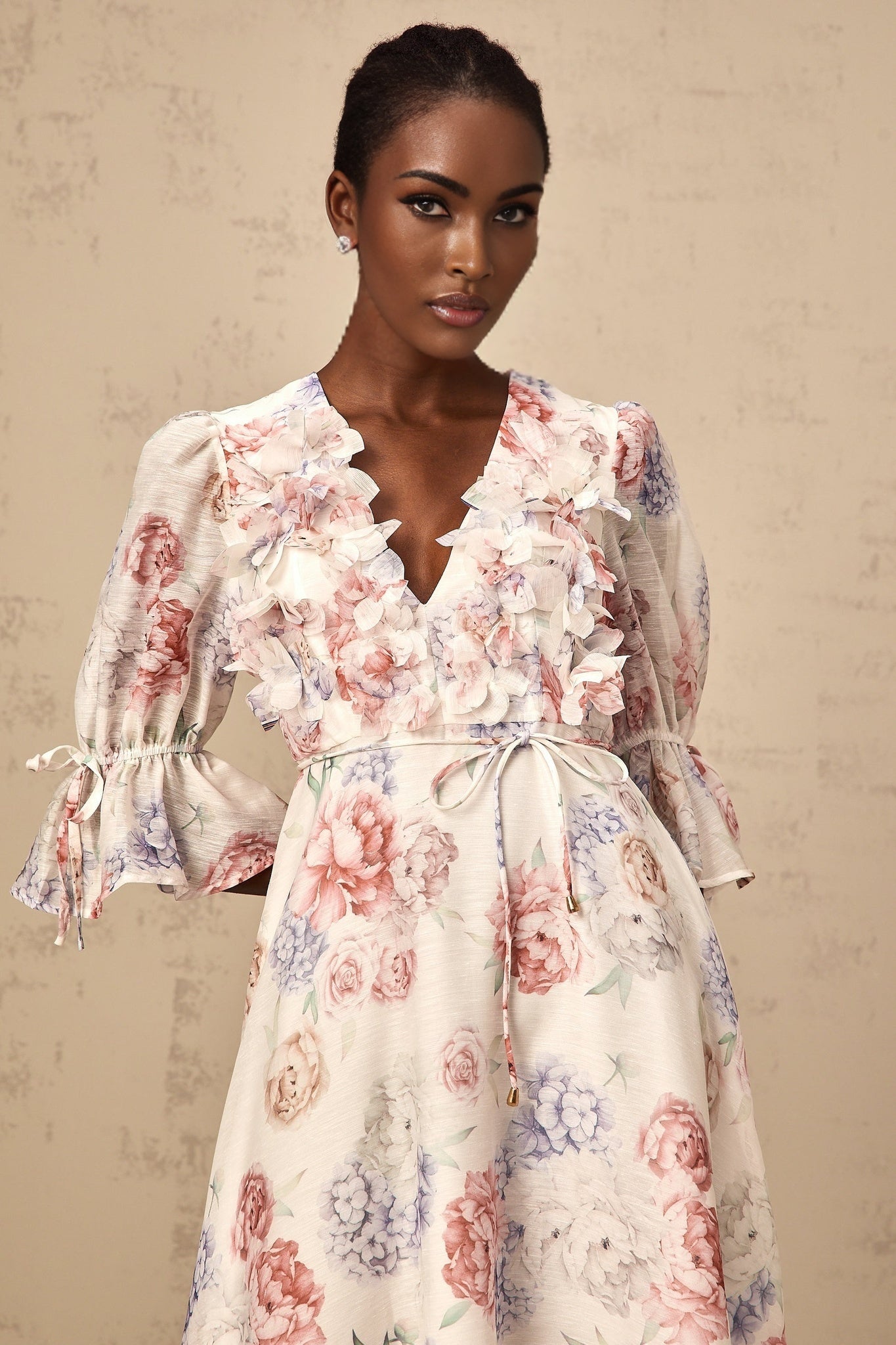 A floral midi dress with a 3d petal print design featuring a tea inspired pattern