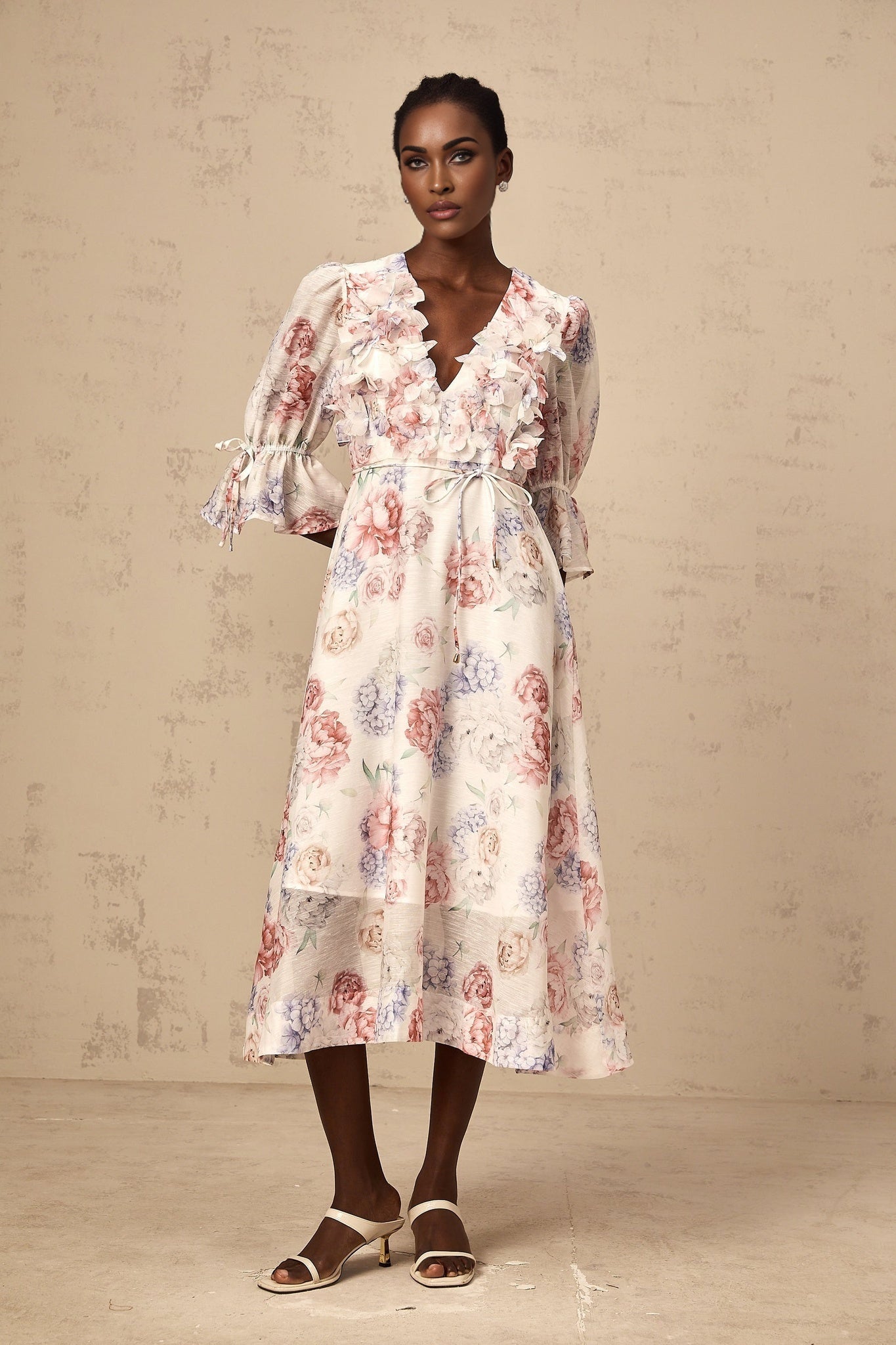 A floral midi dress with a 3d petal print featuring a vibrant pattern and a flattering silhouette