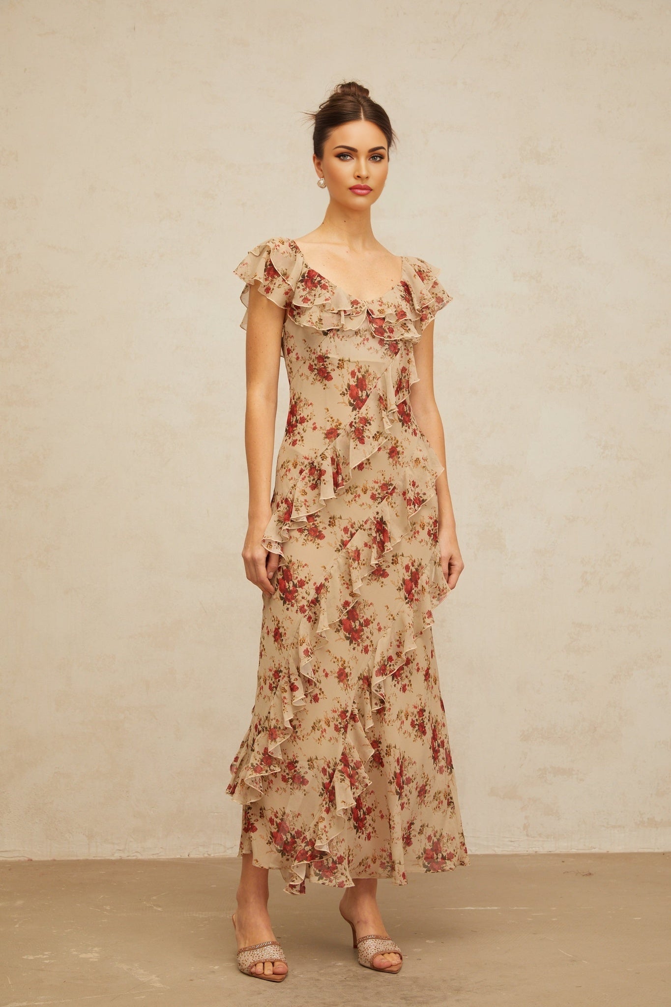 A floral print maxi dress with ruffles and a flared silhouette featuring a long flowing skirt and colorful floral pattern on the fabric