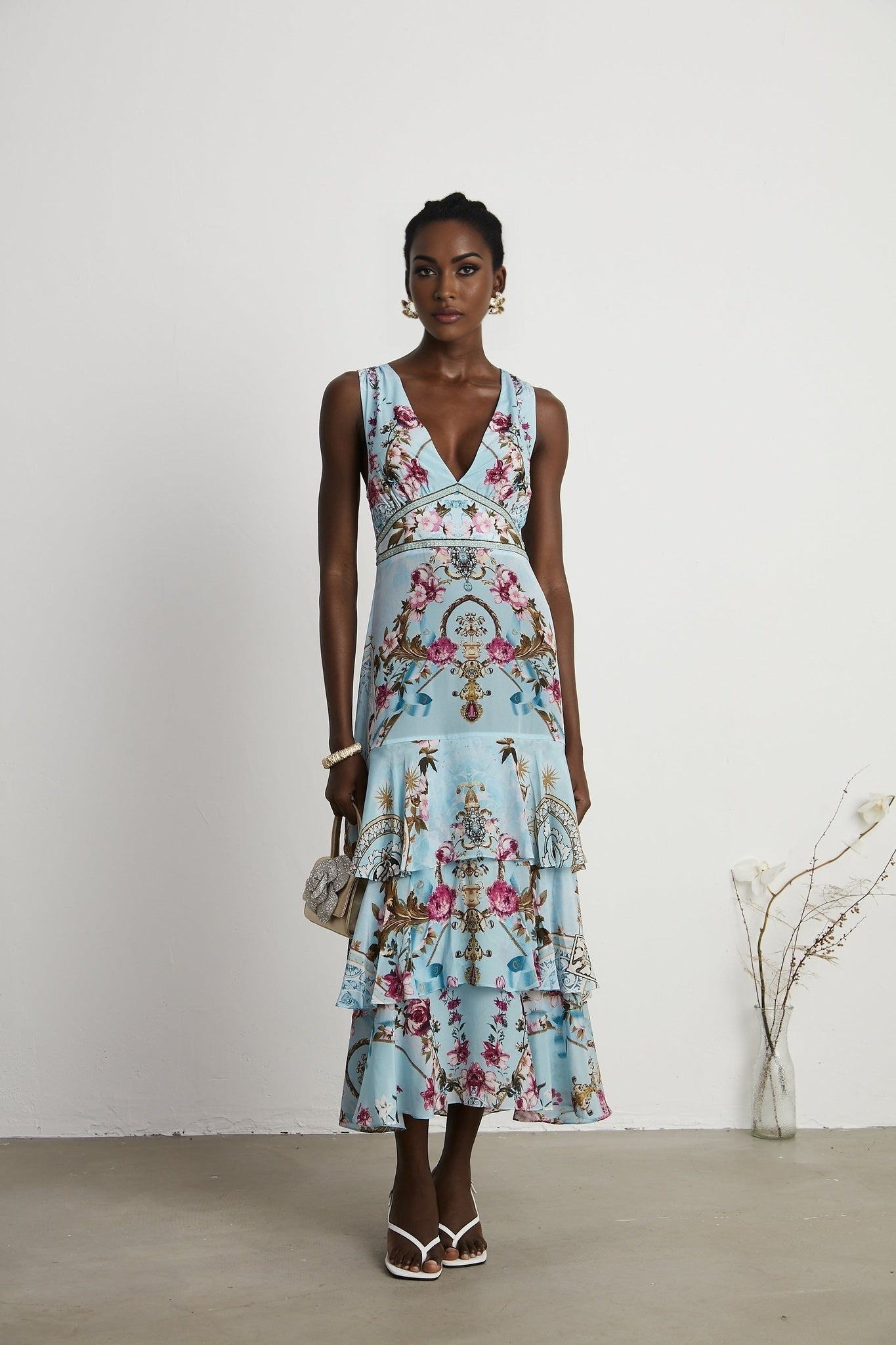 A floral print midi dress in the Victoire style featuring a midlength skirt and allover flower pattern