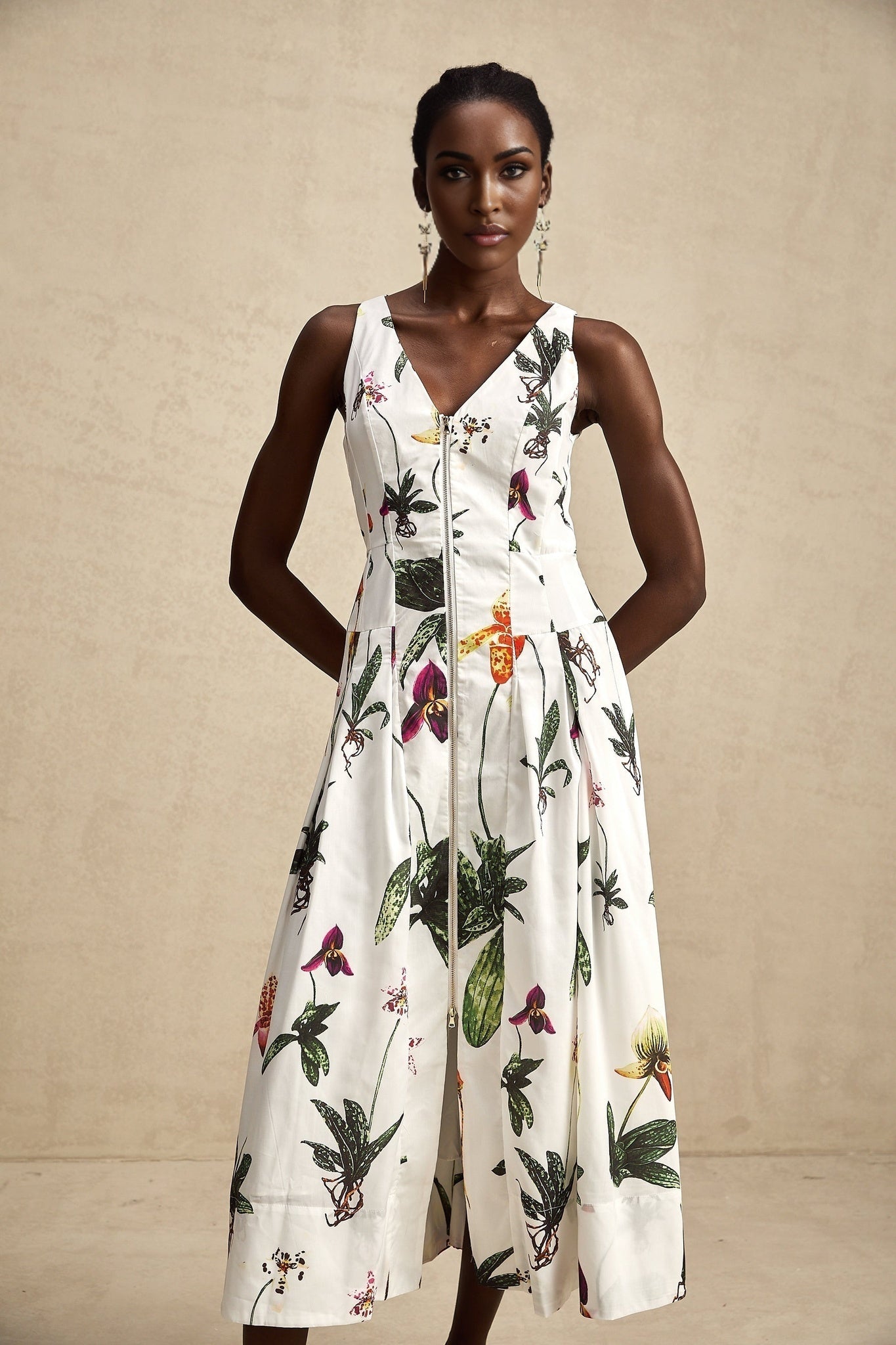 A floral print midi dress with a vneck made from poplin fabric featuring the Magali design