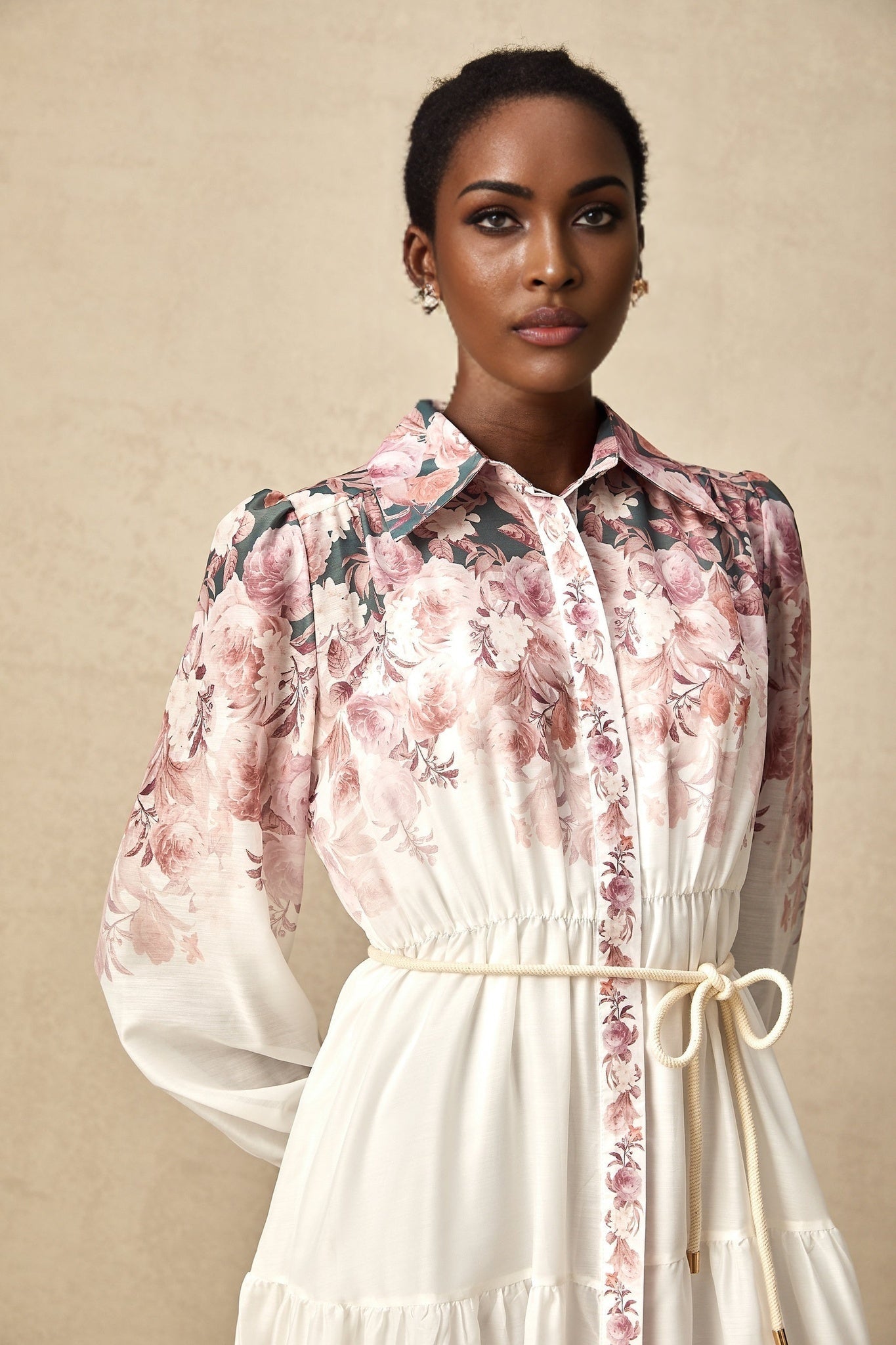A floral print midi dress with lantern sleeves called Carina featuring a vibrant pattern and flowing silhouette