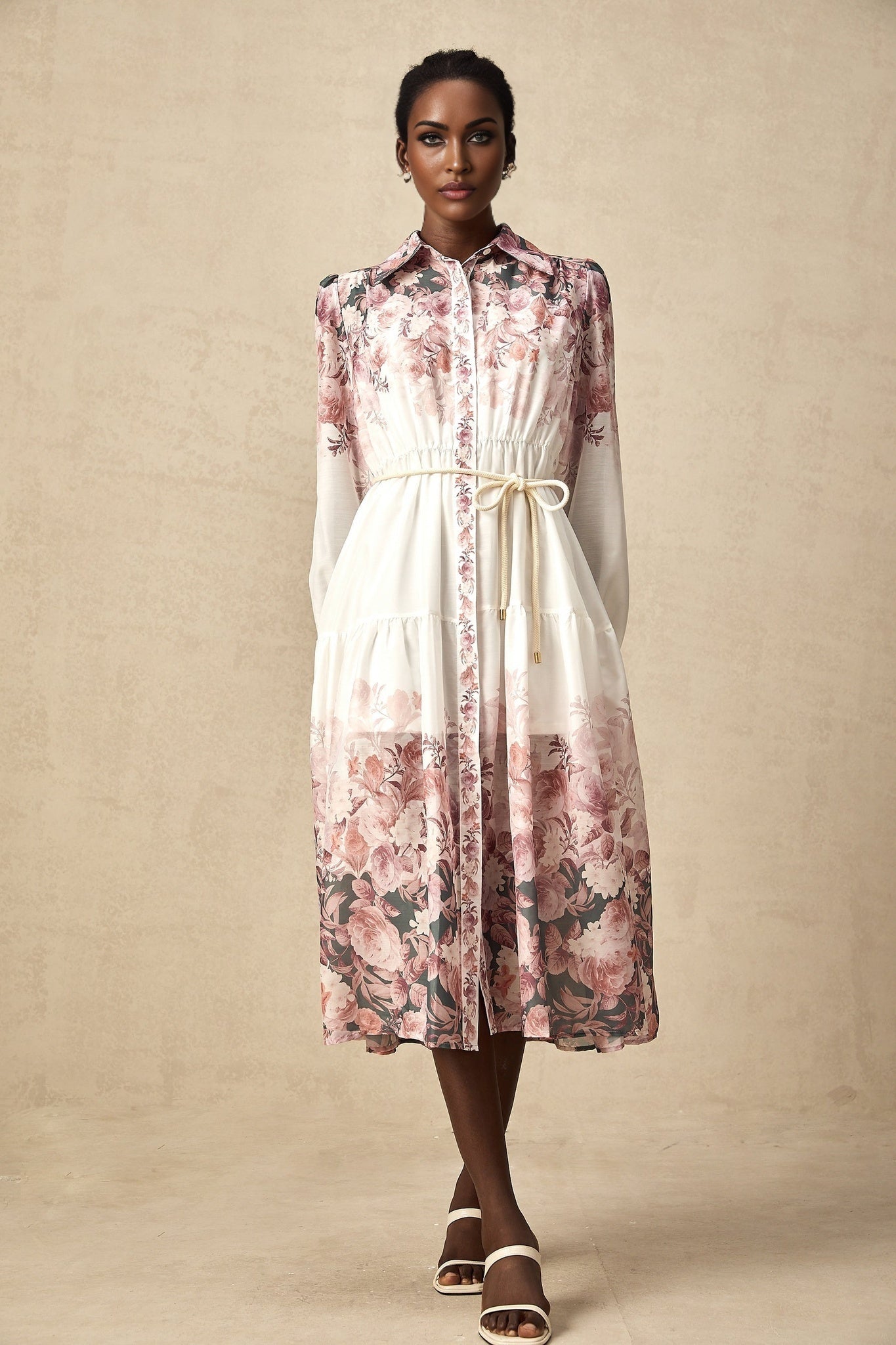 A floral print midi dress with lantern sleeves named Carina featuring a colorful pattern on a light background