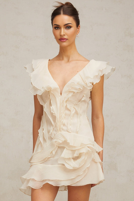 A floral print mini dress with layered ruffles and a faux flower embellishment