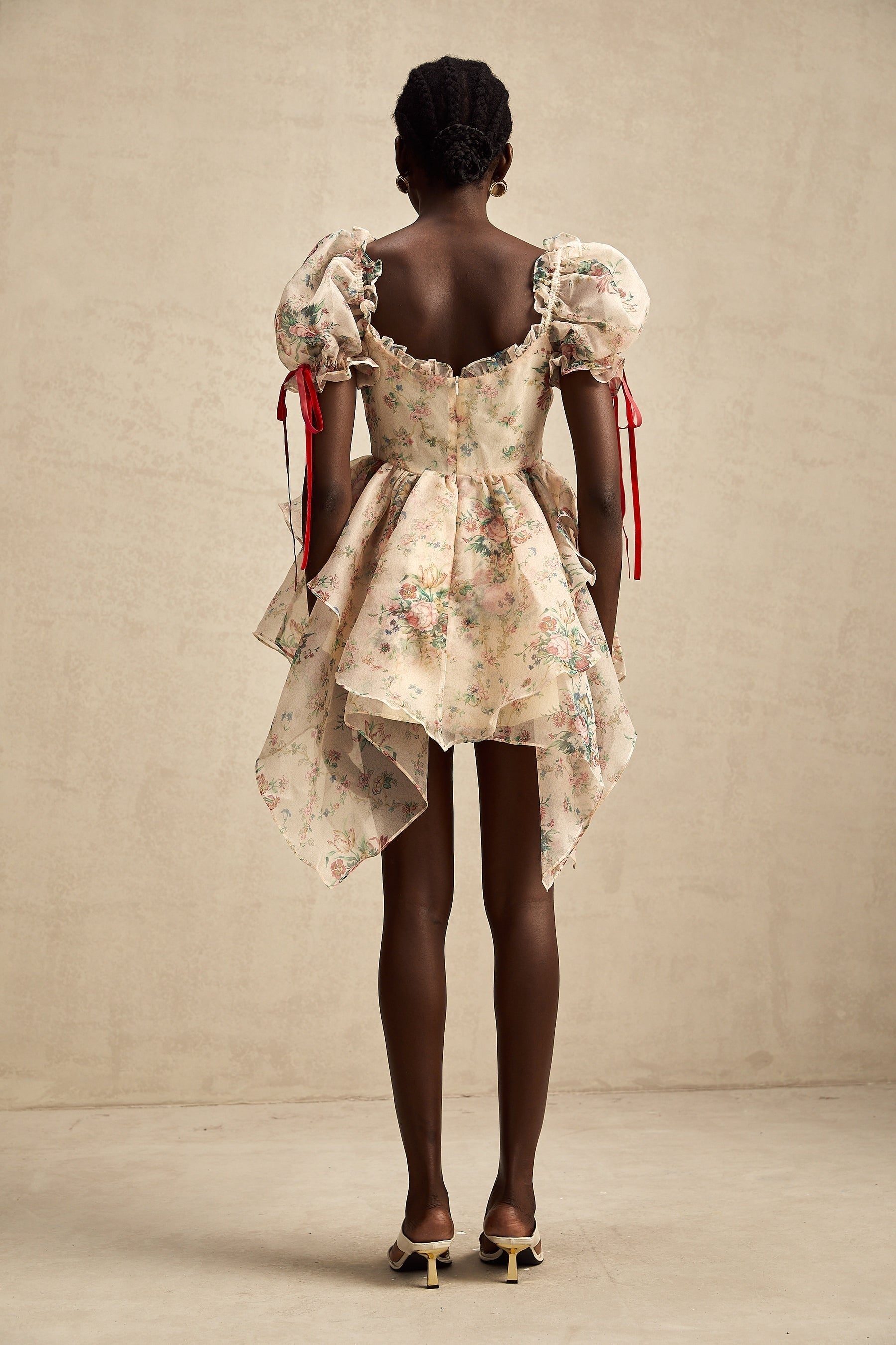 A floral print mini dress with layered tulle skirt and tie up detail named Salome