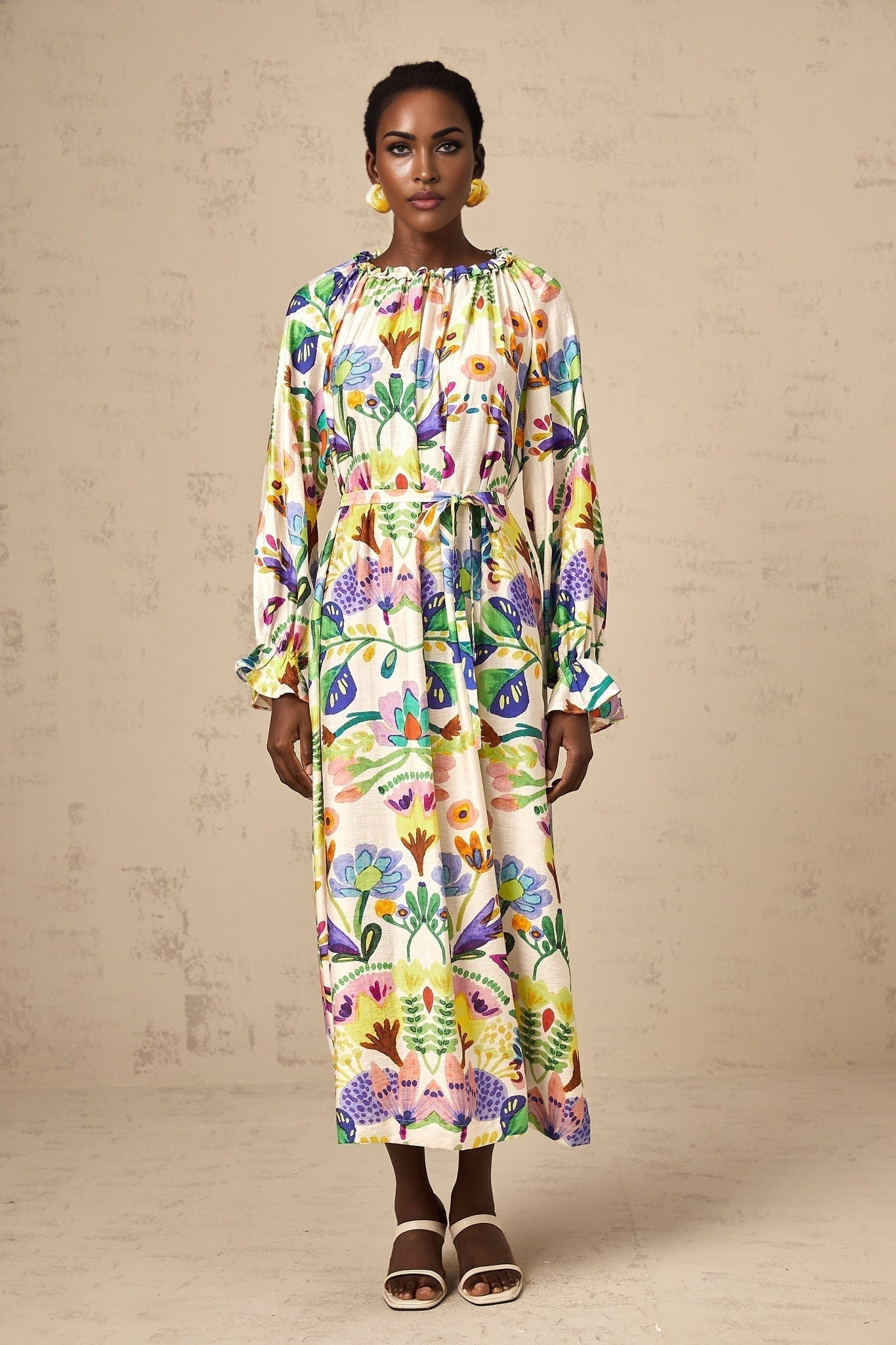 A flowing midi dress with a paisley print pattern on light poplin fabric featuring a vibrant design and feminine silhouette