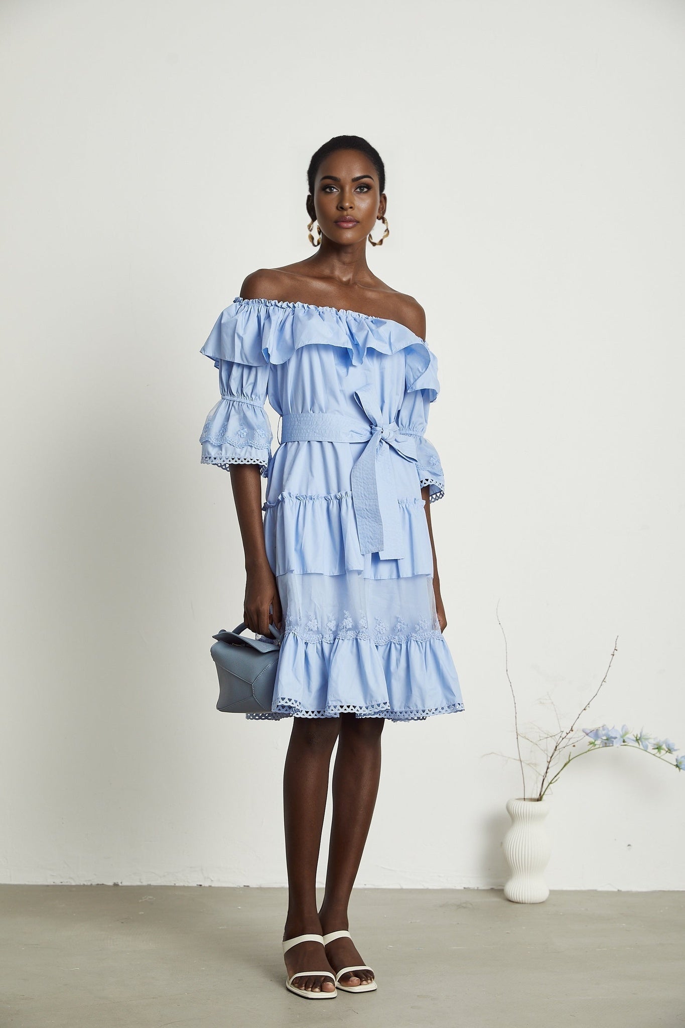 A flowy midi dress with a tiered skirt and offtheshoulder neckline named Sophie