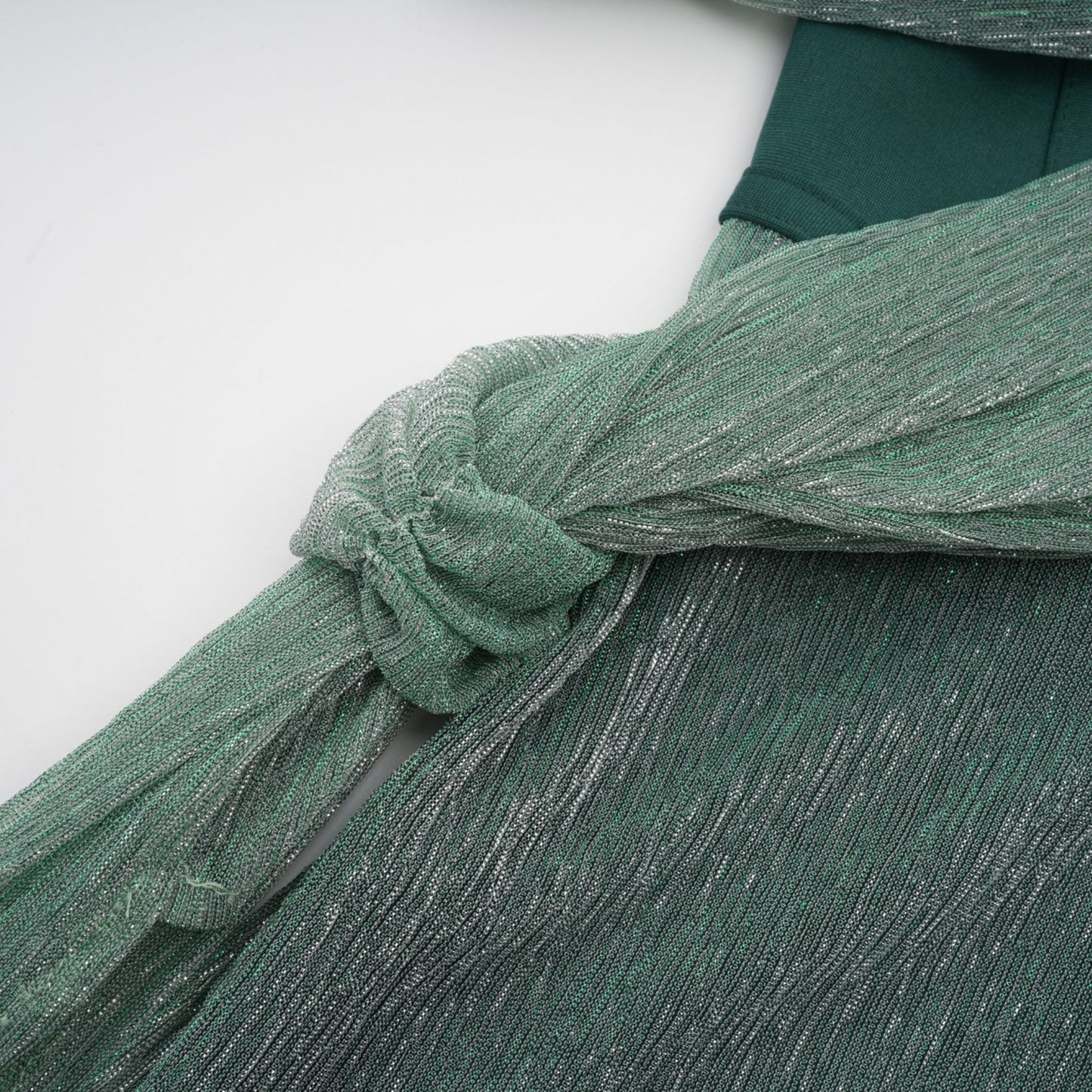 A green maxi dress featuring a corset bodice with ribbon design details and a long flowing skirt