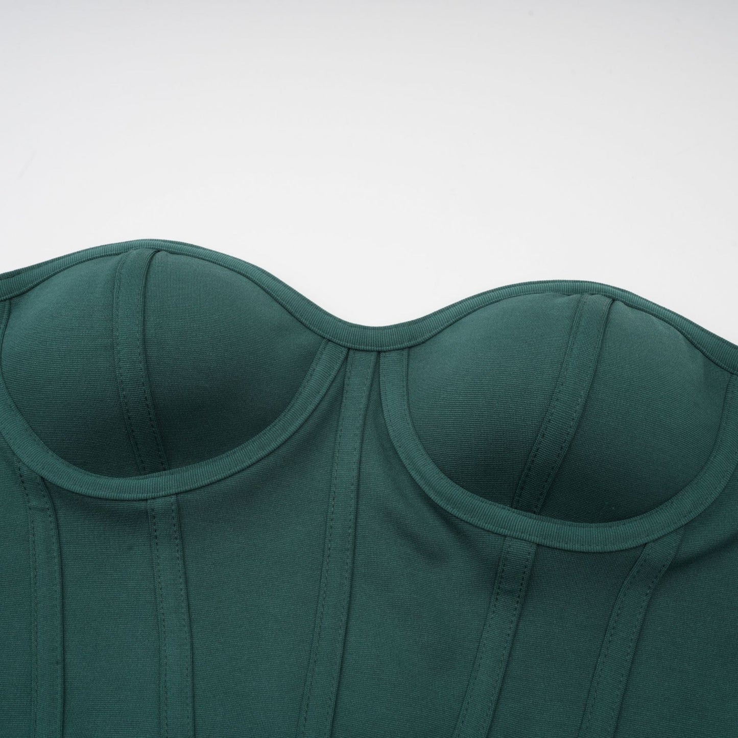 A green maxi dress featuring a corset bodice with ribbon detailing and a long flowing skirt