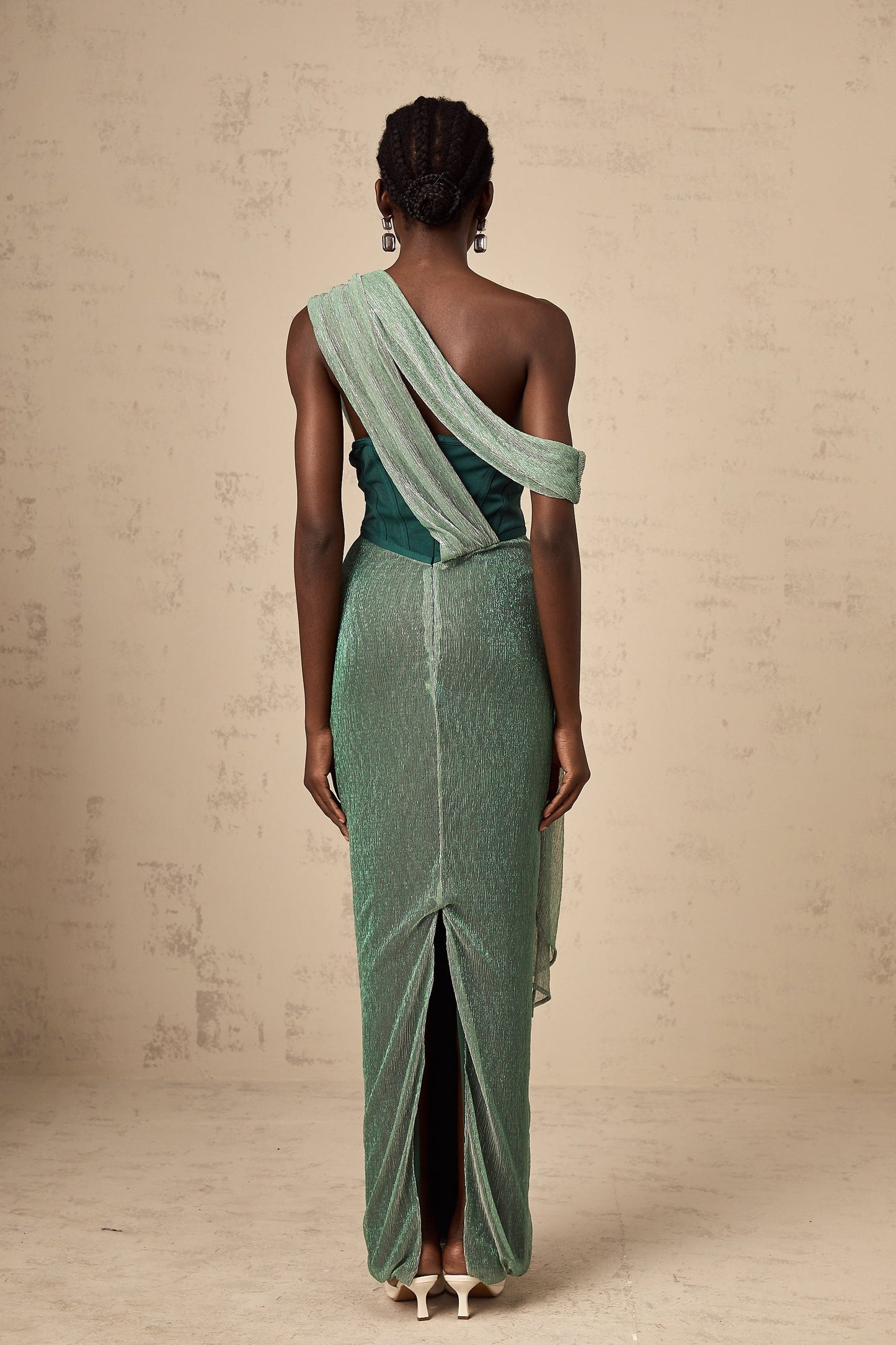 A green maxi dress with a corset bodice featuring a ribbon design and a long flowing skirt