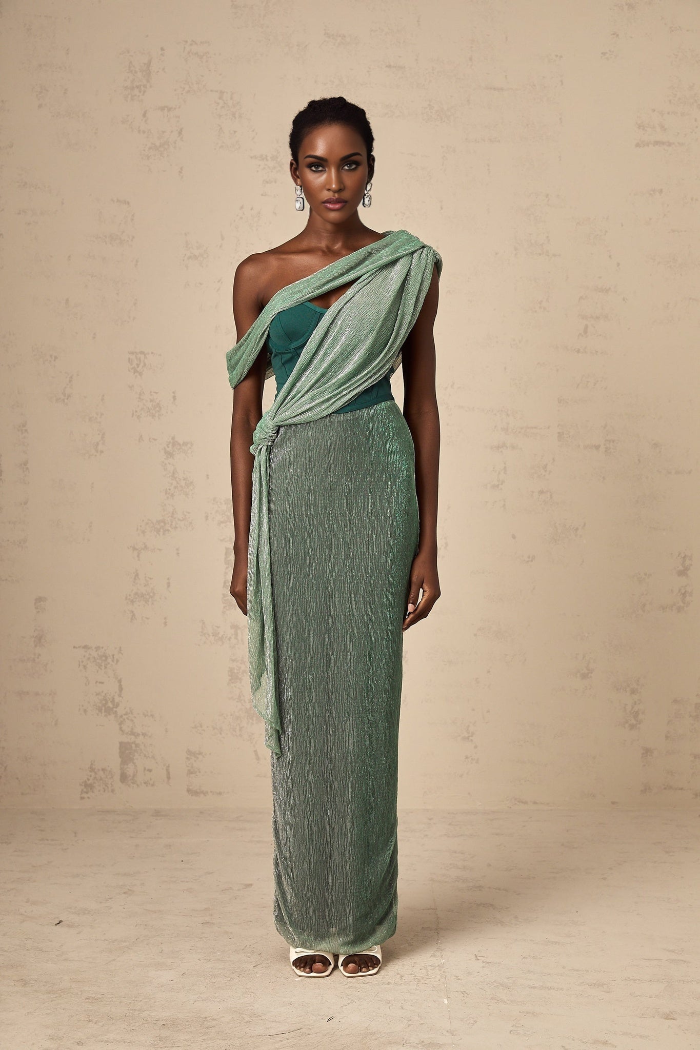 A green maxi dress with a corset bodice featuring a ribbon design and a long flowing skirt