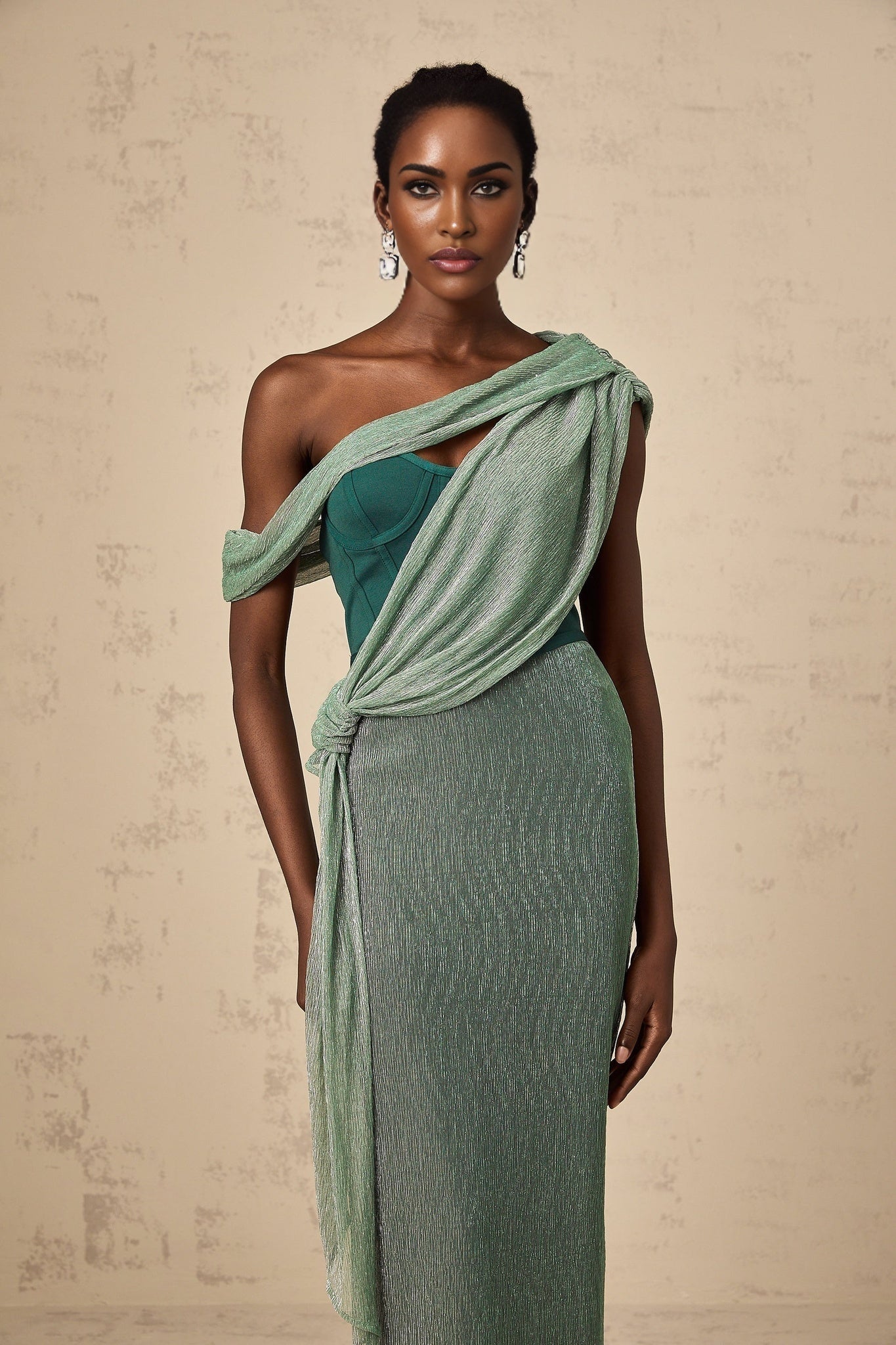 A green maxi dress with a corset bodice featuring ribbon design details and a flowing long skirt