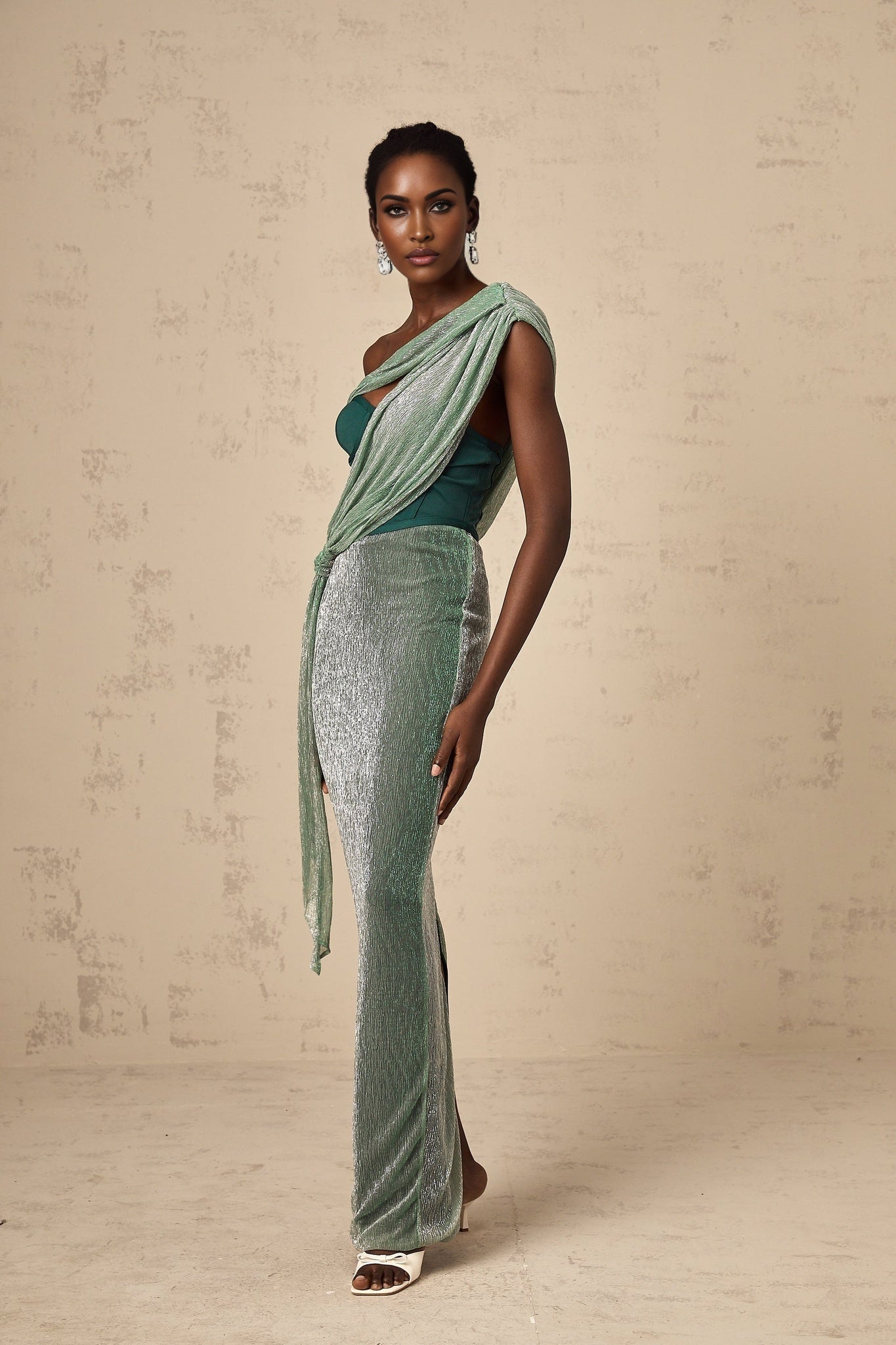 A green maxi dress with a corsetstyle bodice featuring a ribbon design and a long flowing skirt