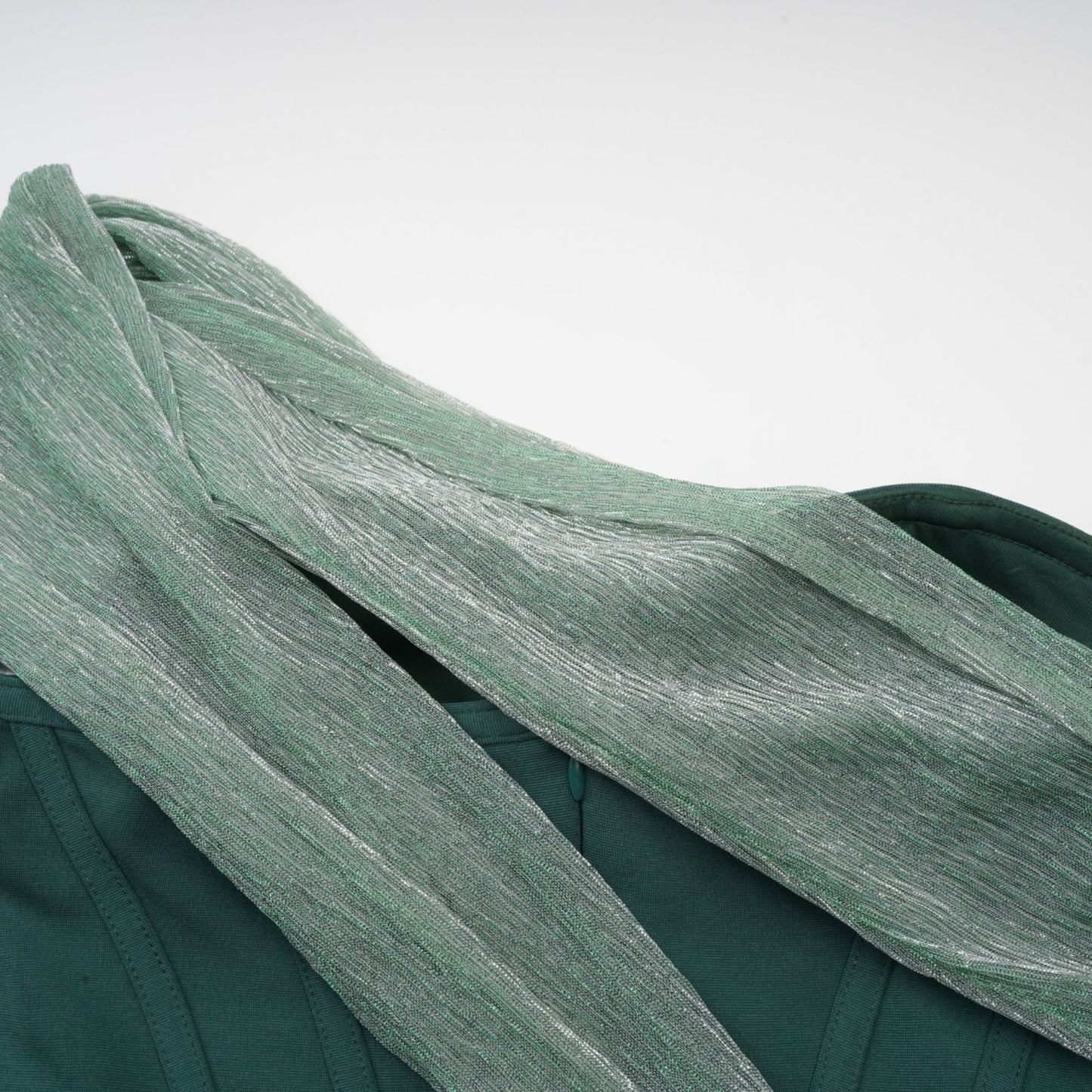 A green maxi dress with corset bodice featuring ribbon design details and long flowing skirt