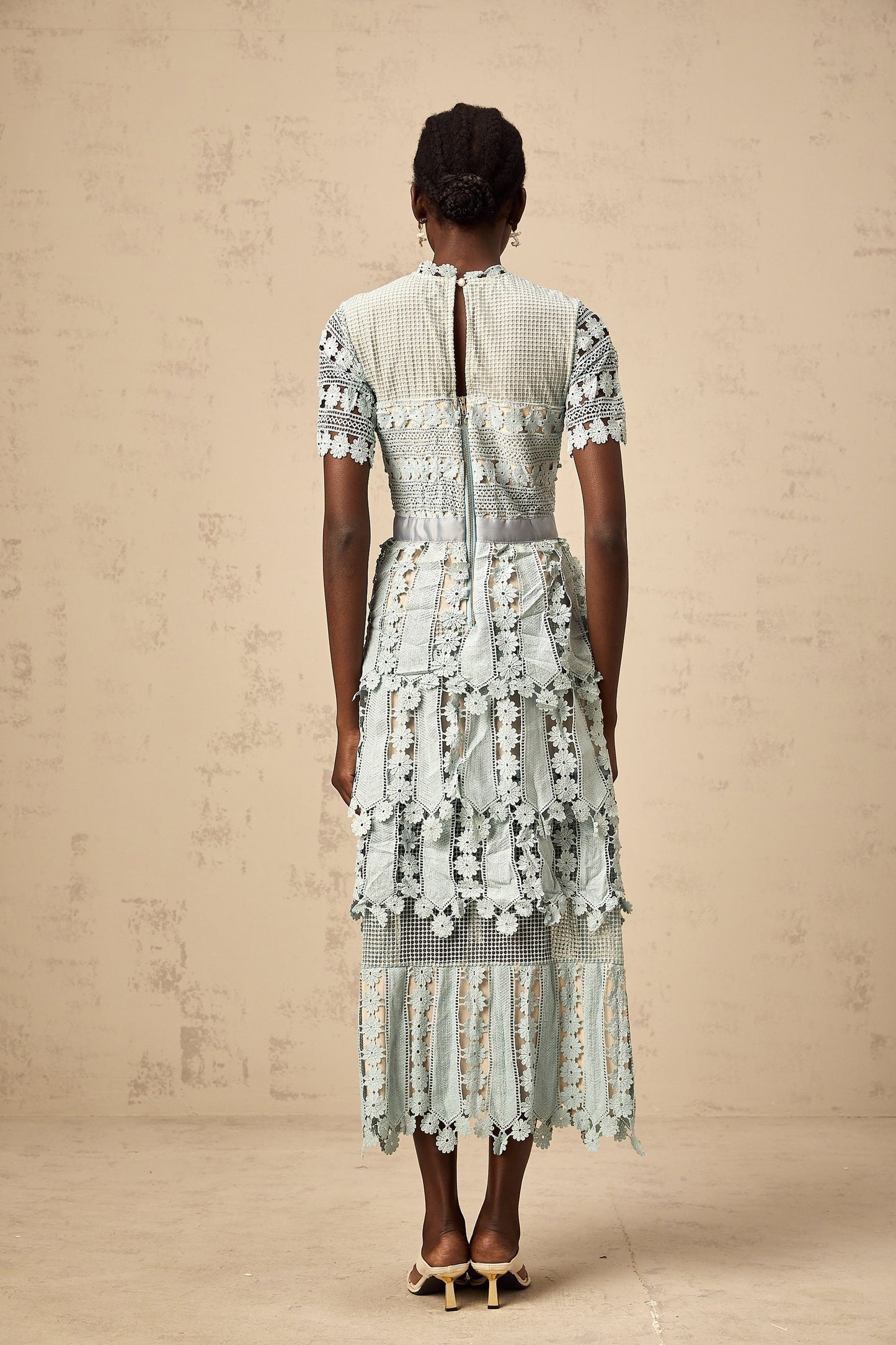 A green midi dress with floral embroidery details featuring a design inspired by ocean themes