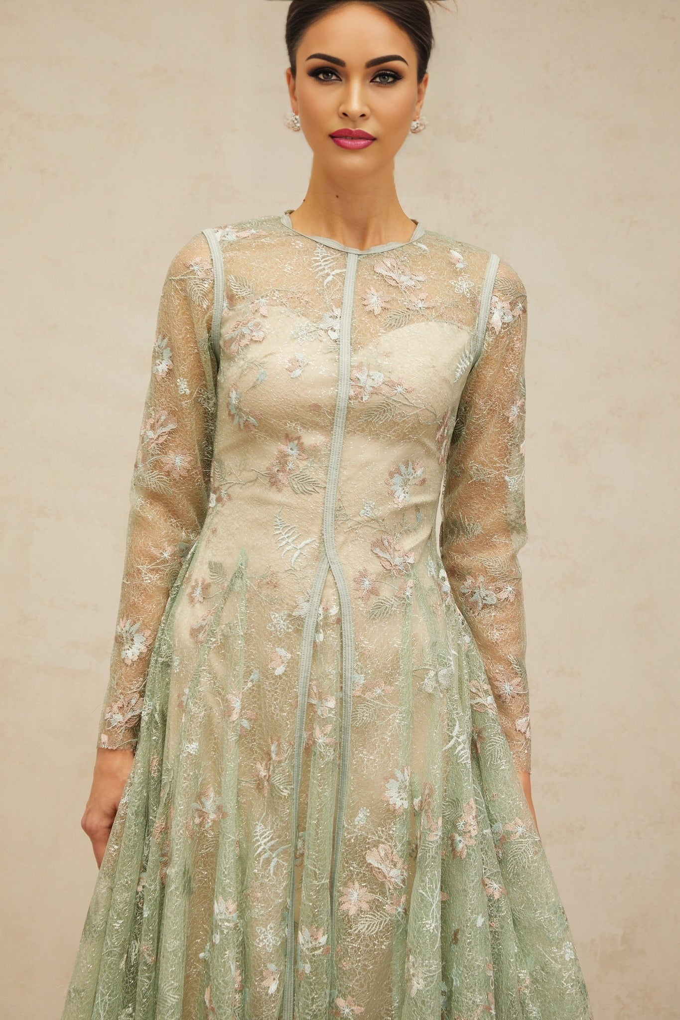 A green pleated midi dress with floral embroidery details named Philomene
