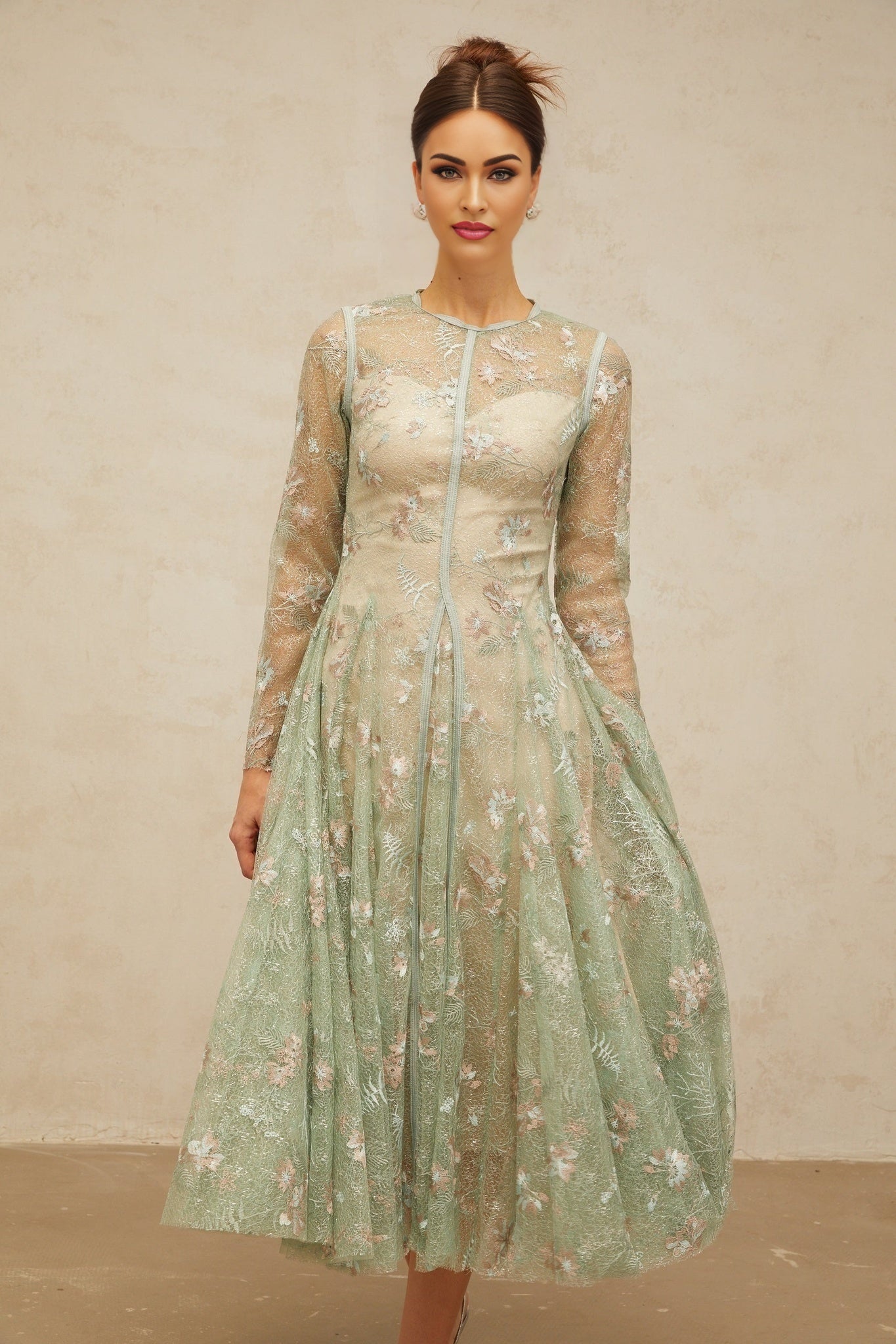 A green pleated midi dress with floral embroidery details named Philomene