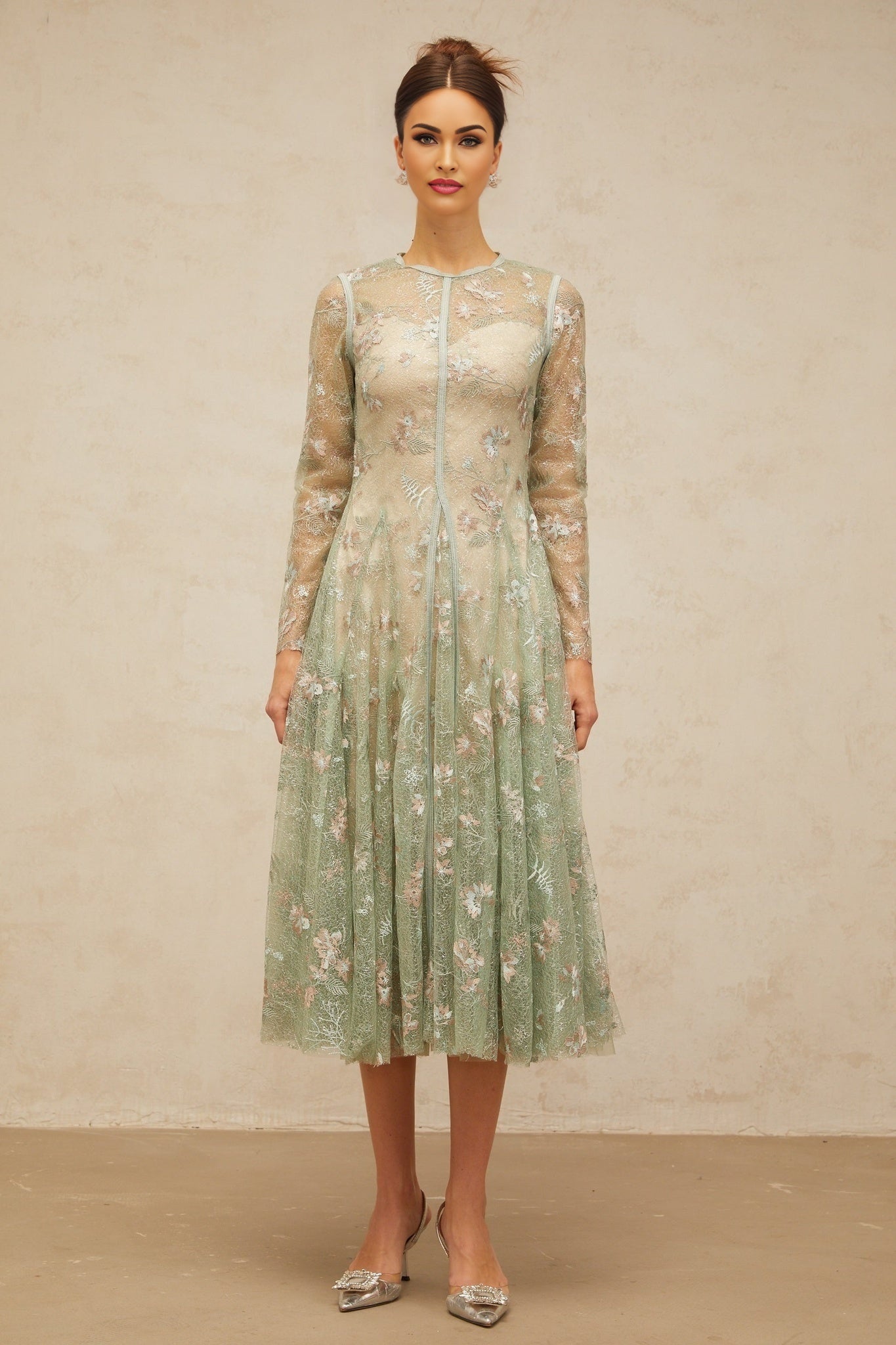 A green pleated midi dress with floral embroidery featuring a design called Philomene