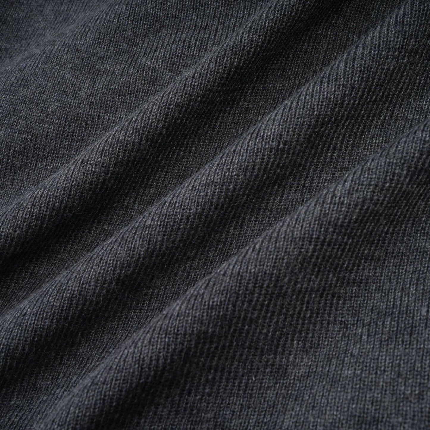 A grey cardigan with sequined butterfly designs adorning the fabric