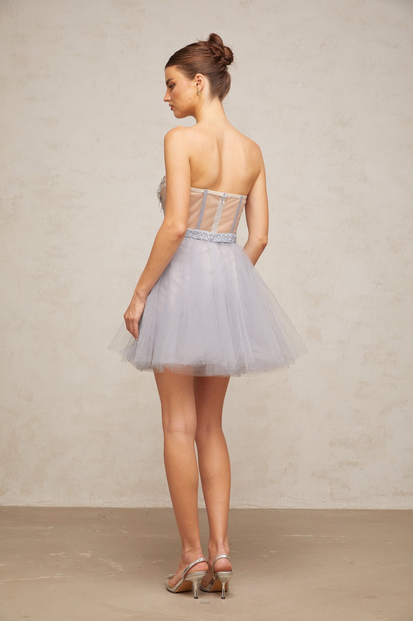 A grey mini dress with puff sleeves and tulle skirt featuring embellishments