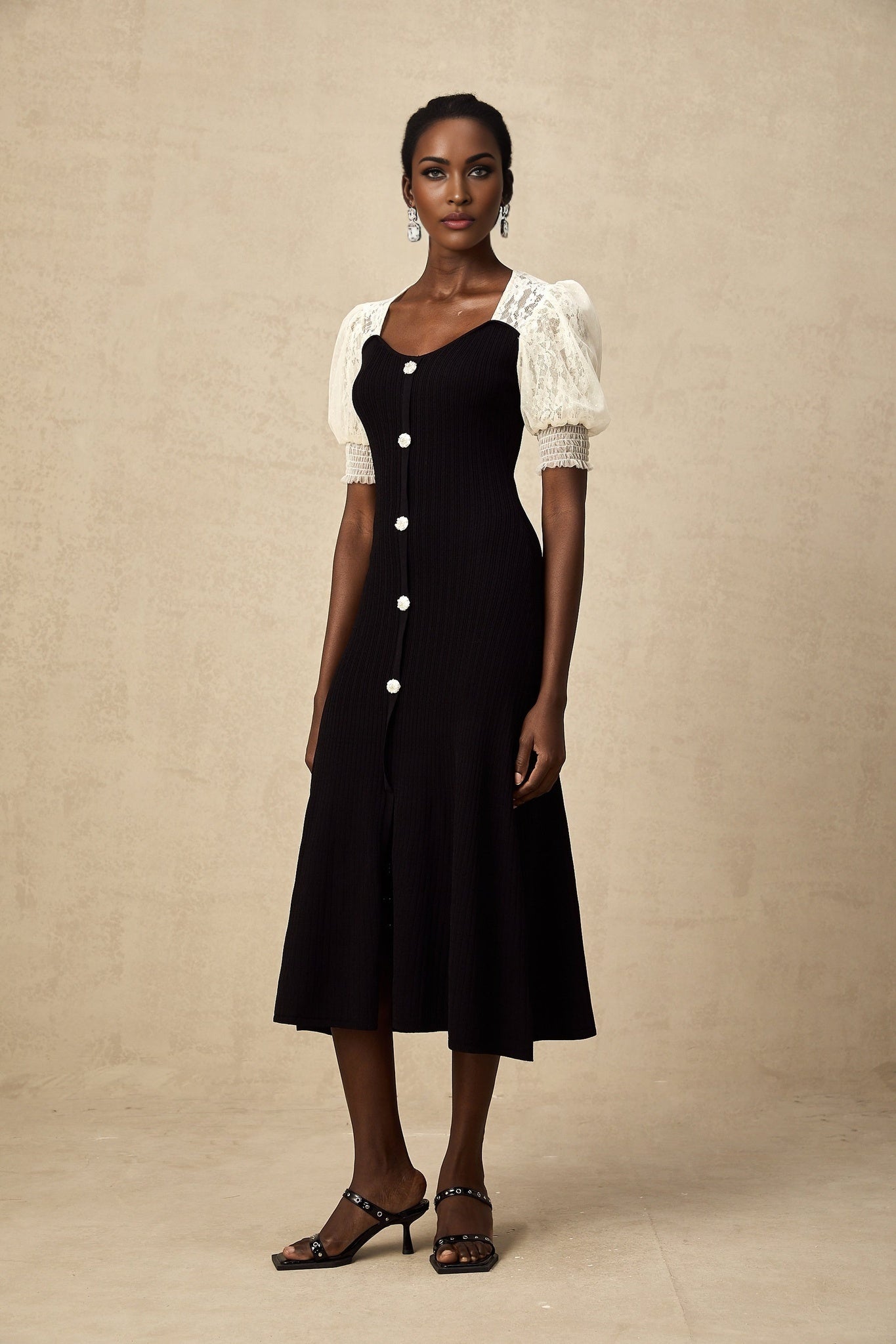 A knit midi dress with lace trim detailing named Noa