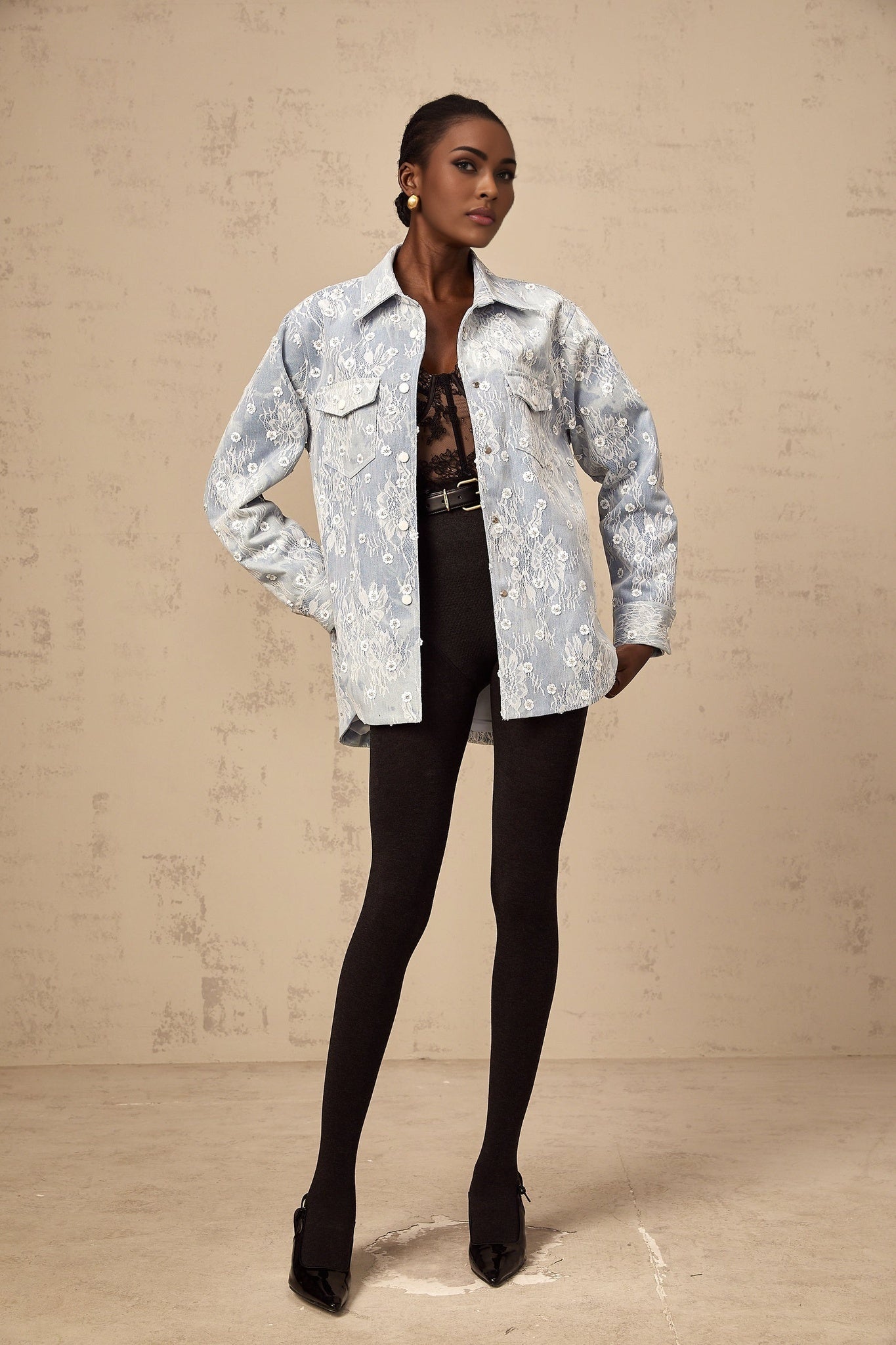 A light blue denim jacket adorned with sequined floral appliques and embellishments