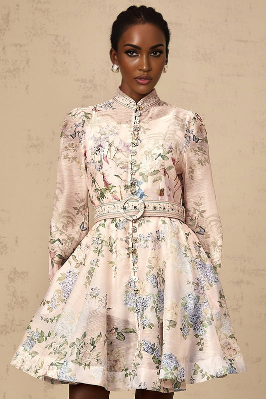 A light pink mini dress with a floral print pattern covering the fabric