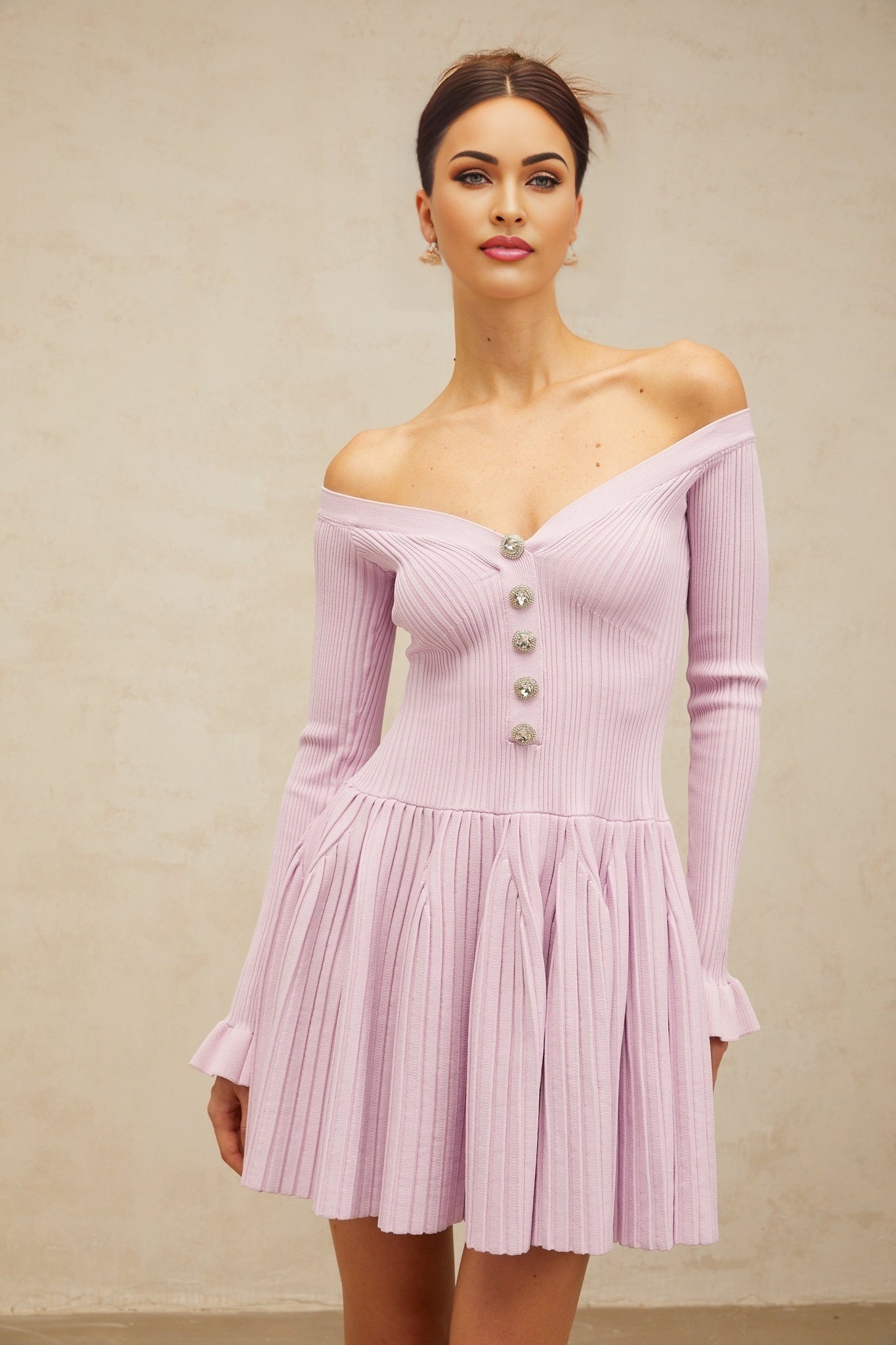 A light purple offshoulder mini dress with ribbed knit fabric and a formfitting silhouette