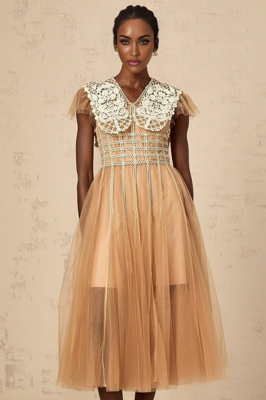 A lightcolored midi dress with lace panels and tulle details featuring a delicate and feminine design