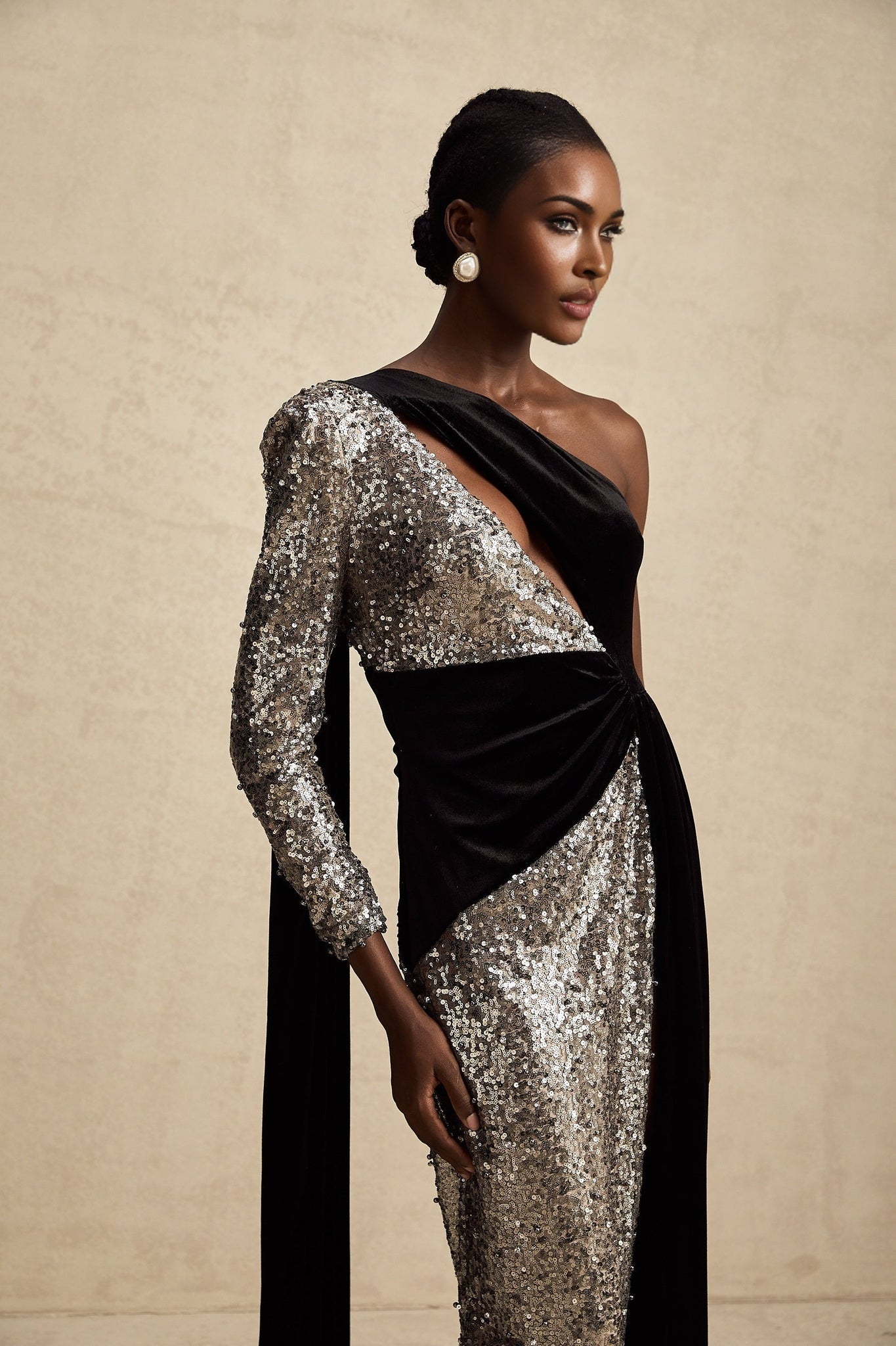 A long asymmetric maxi dress with sequin embellishments named Juliette featuring a sparkly design and uneven hemline