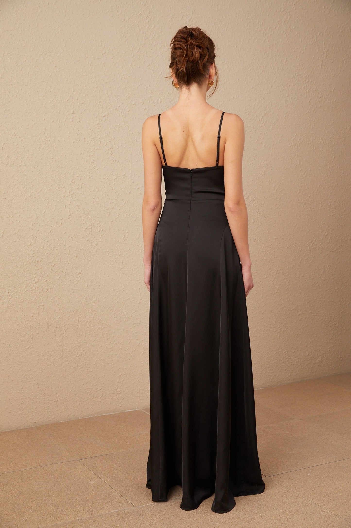 A long black satin maxi dress with a V neckline and front slit named Blanche