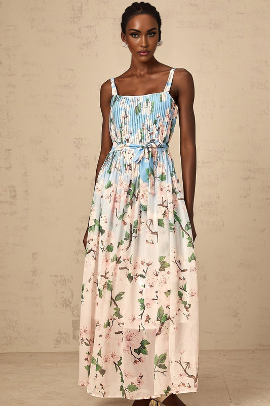 A long blue maxi dress with a floral print pattern and pleated design