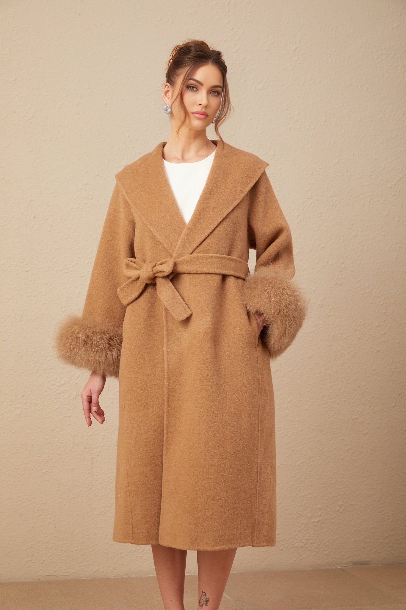 A long brown woolen overcoat with a felted texture and wrap style design