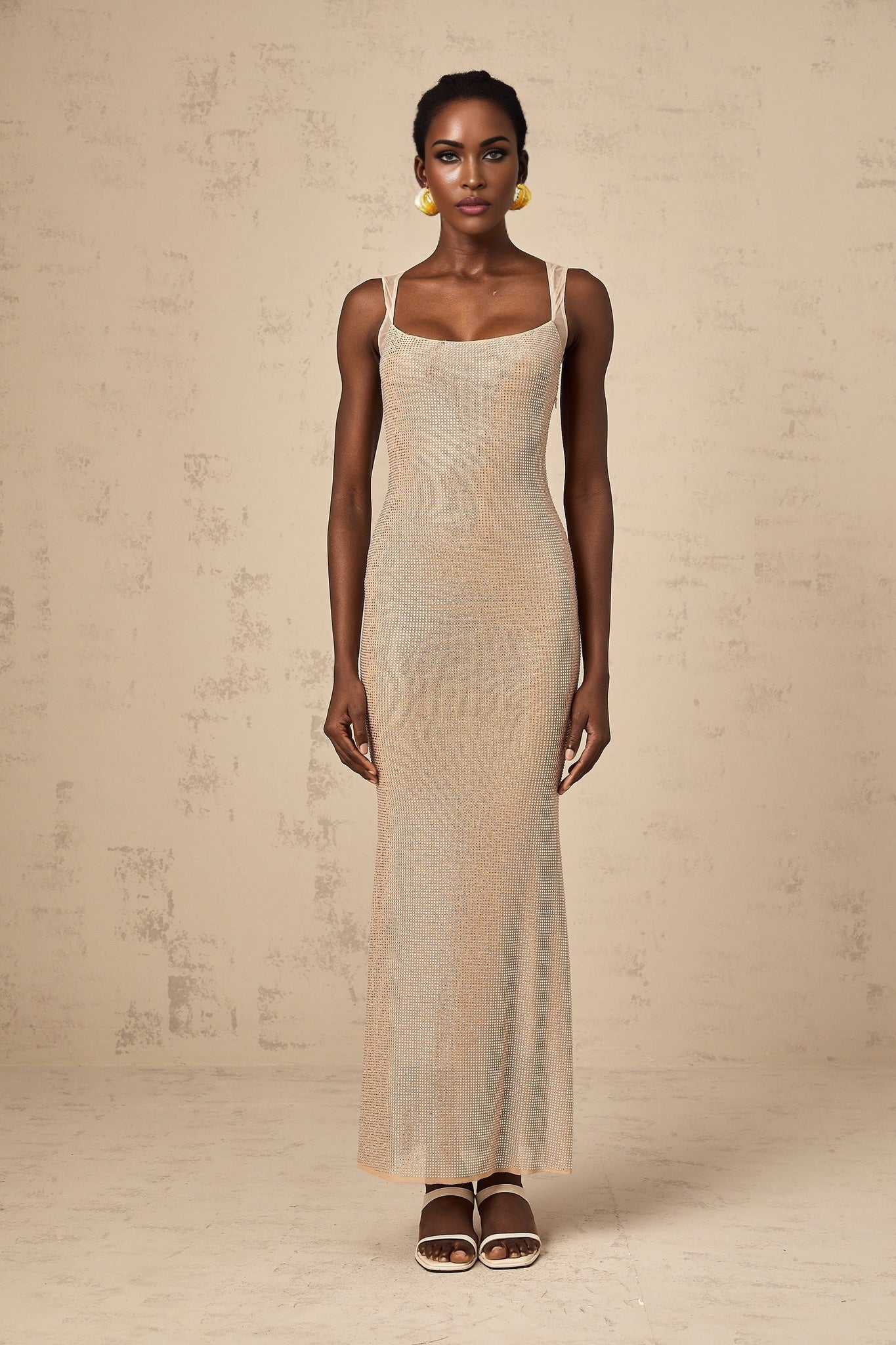 A long elegant maxi dress with crystal embellishments and an open back design