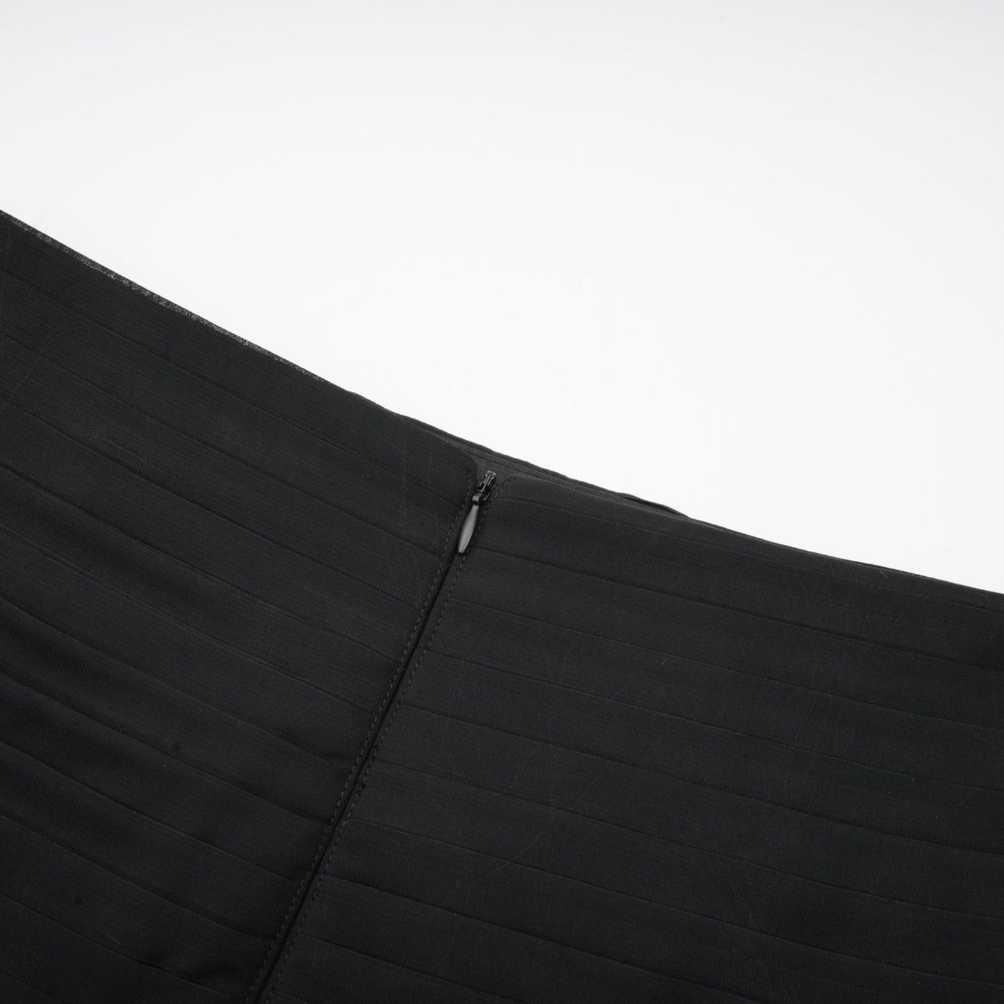 A long flowing maxi skirt with layers of ruffled tulle fabric in a pleated design featuring a rayon waistband