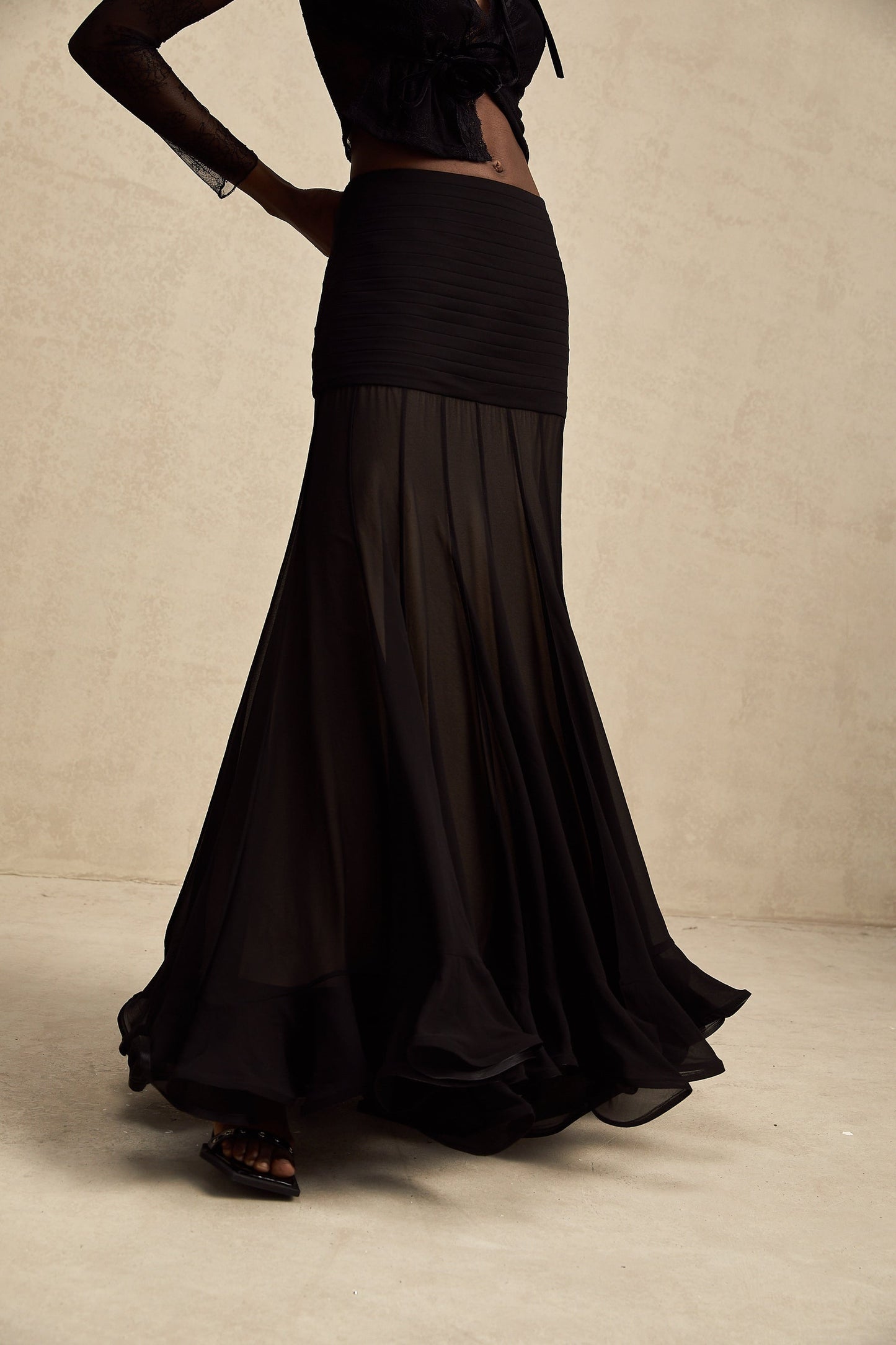 A long flowing maxi skirt with ruffles and pleats made of rayon and tulle fabric in a Jacqueline style