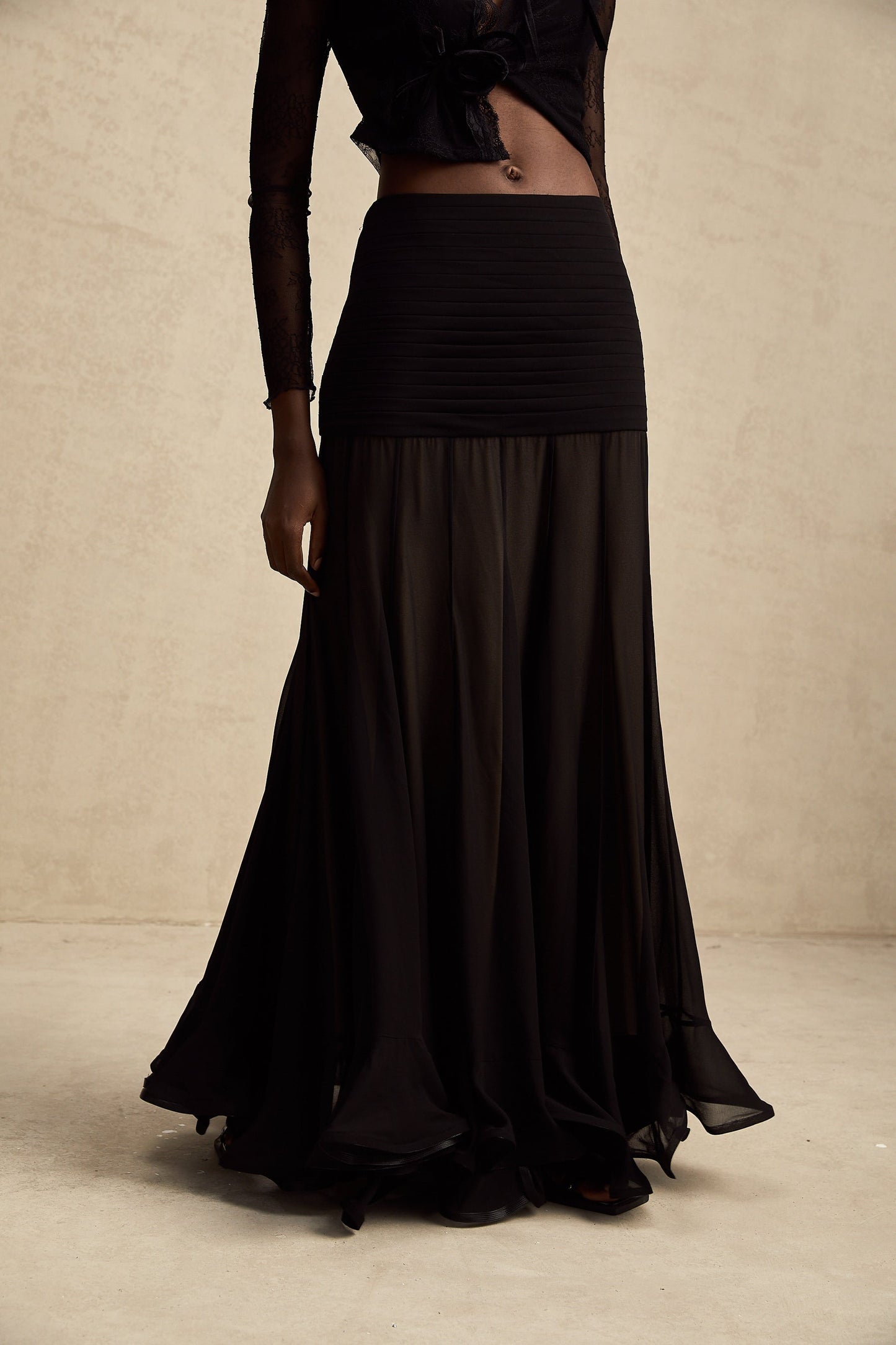 A long flowy maxi skirt with ruffles and pleats made of rayon and tulle fabric in a Jacqueline style