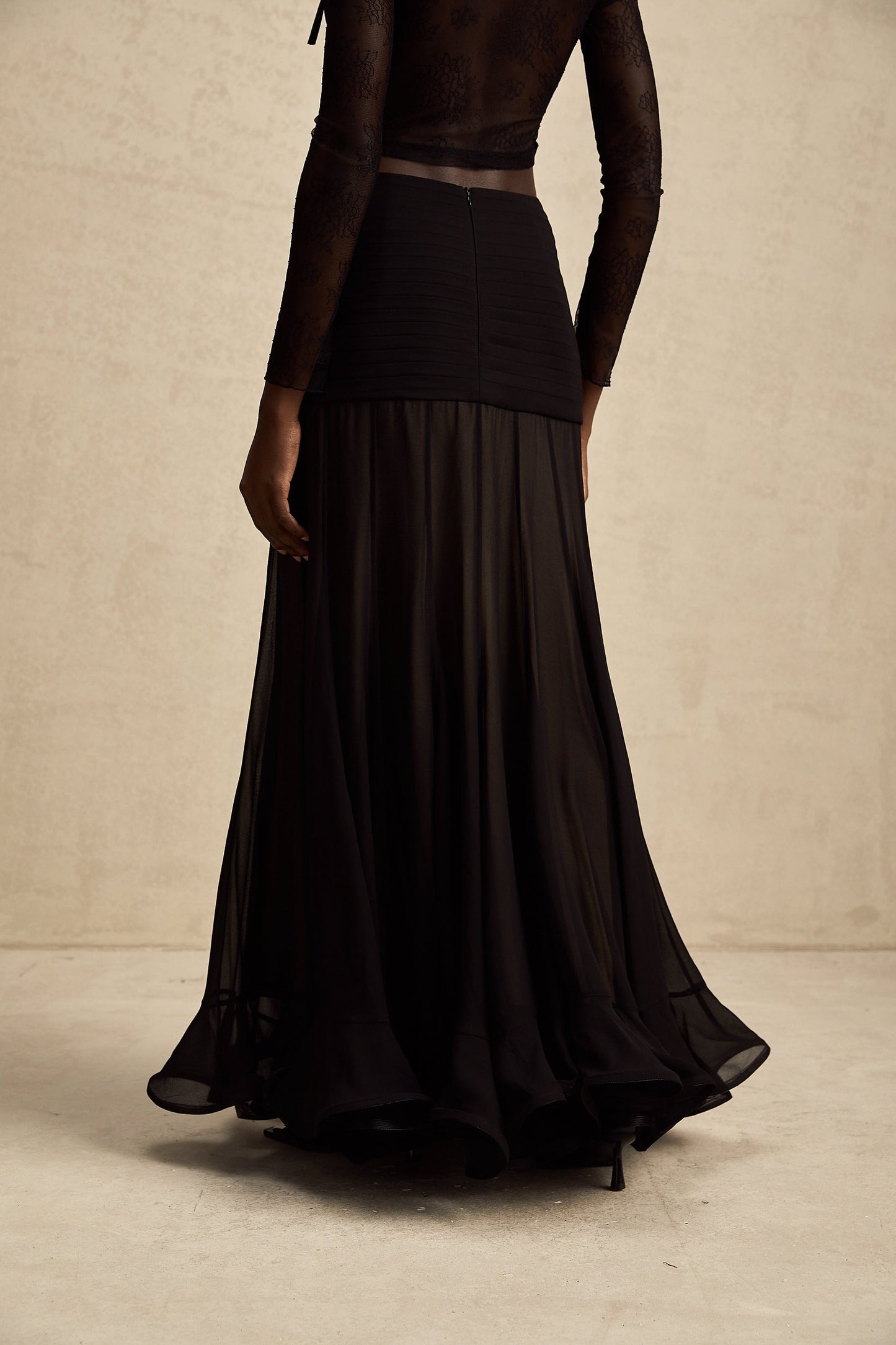 A long flowy maxi skirt with ruffles and pleats made of rayon and tulle fabric in a light feminine style