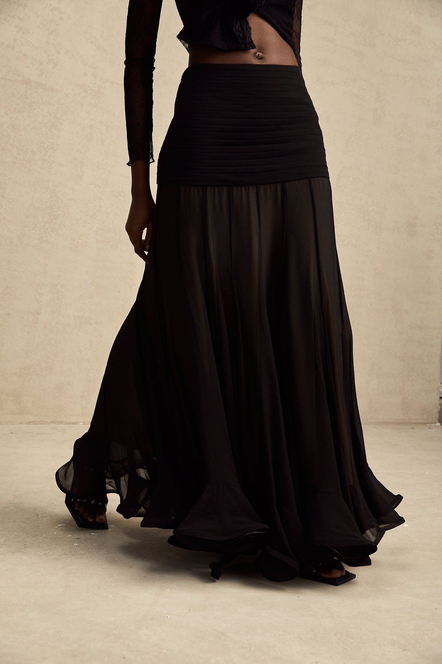 A long flowy maxi skirt with ruffles and pleats made of rayon and tulle fabric in a soft Jacqueline style