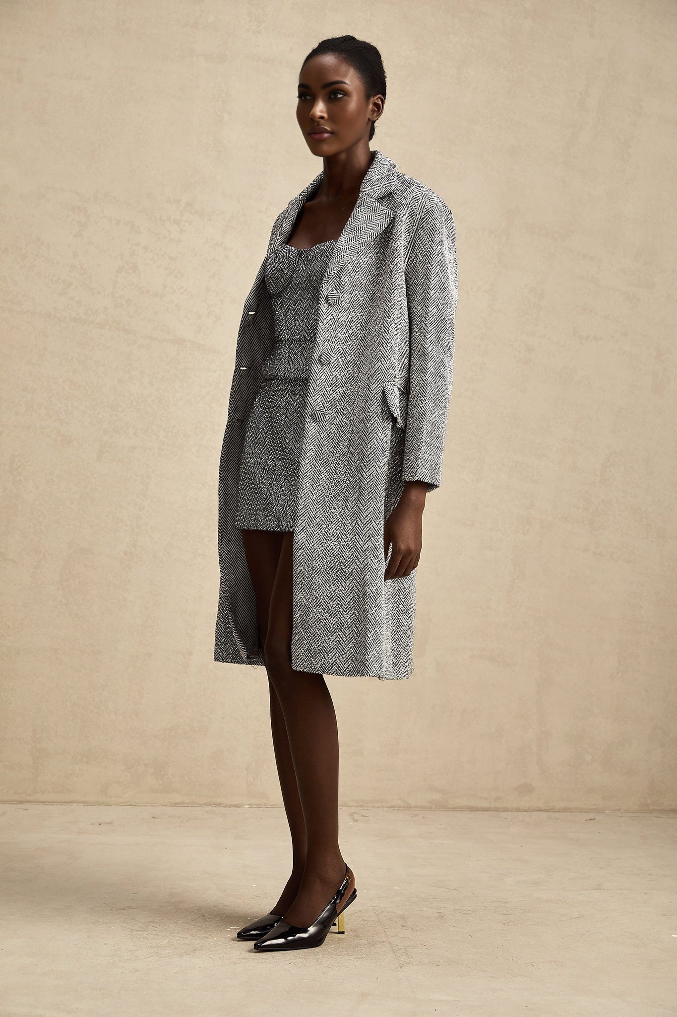 A long gray coat with a herringbone pattern called Chantal