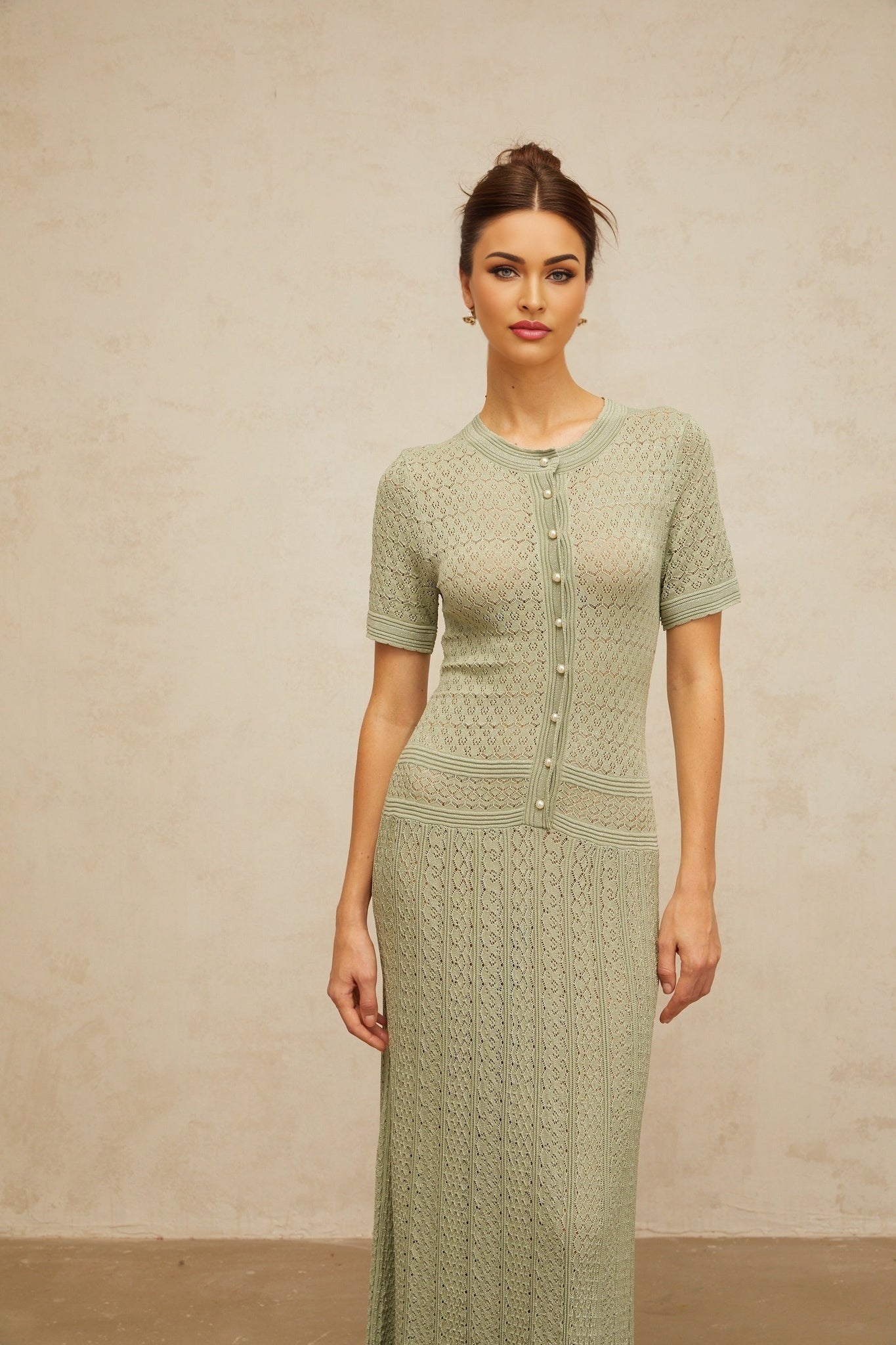 A long green maxi dress with shirred detailing and crochet knit fabric